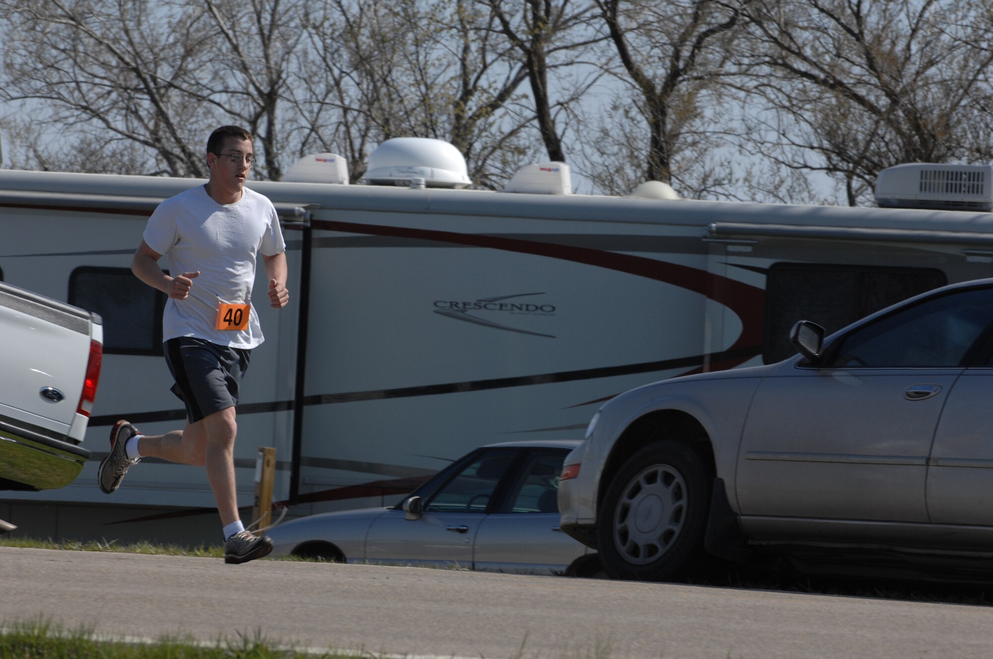 MINOT AIR FORCE BASE, N.D.—Airman 1st Class Matthew Beers, structural apprentice 5th Civil Engineer Squadron runs during the Why Not Run event here May 16.  Beers took first place to with a time of 18 minutes, 47 seconds.  The event was hosted by the 5th Force Support Squadron to promote physical fitness and team building.  (U.S. Air Force photo by Staff Sgt. Angel Gallardo)