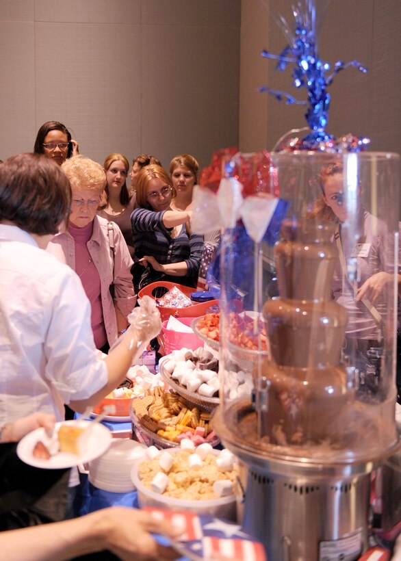 LANGLEY AIR FORCE BASE, Va. -- Military spouses wait in line to try out a chocolate fountain at the Hampton Roads Convention Center May 15 at "A Night Under The Stars." The event , organized for wives of military members, included lots of freebies like massages, a live band and beverages. (U.S. Air Force photo/Airman 1st Class Jonathan Koob (U.S. Air Force photo/Airman 1st Class Jonathan Koob)