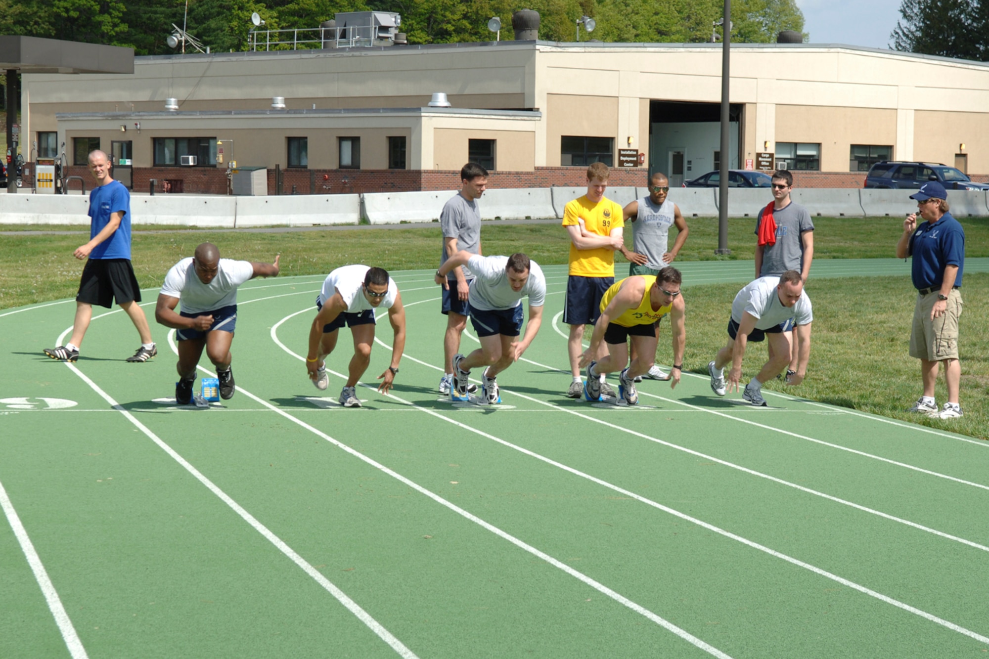 HANSCOM AIR FORCE BASE, Mass. –Runners sprint out of the starting blocks during one of the Hanscom Olympics track competitions on May 15.  The Olympic competition began May 11 and will close on May 21 with an awards ceremony at noon and a base picnic to immediately follow.  The games included a 5K Run; bowling; dodge ball; frisbee football; kickball; racquetball; tennis; track and swim sprints; and tug of war. (U.S. Air Force photo by Rick Berry) 