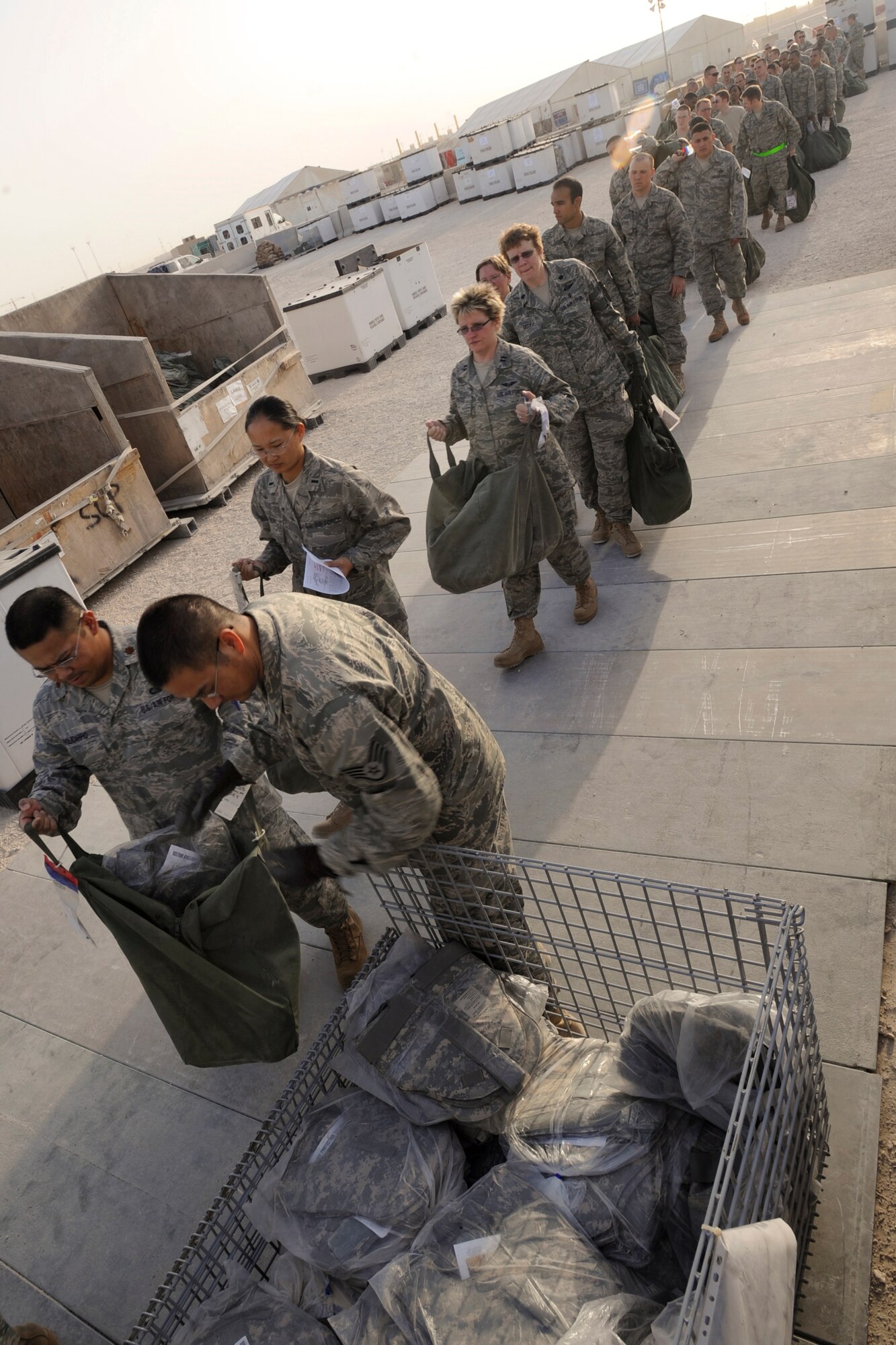 Staff Sgt. James Riger, a mobility specialist with the 379th Expeditionary Logistic Readiness Squadron, hands out protective equipment to transient personnel here, May 19, 2009, in an undisclosed location in Southwest Asia.  Sergeant Riger and fellow mobility specialists at the expeditionary theater distribution center ensure all transient and forward deploying Air Force personnel are properly equipped prior to reaching their final destination in the U.S. Central Command's area of responsibility.  Sergeant Riger is native to Reno, Nev. and is deployed from the Reno National Guard, Nev. in support of Operations Iraqi and Enduring Freedom and Combined Joint Task Force - Horn of Africa.  (U.S. Air Force Photo by Staff Sgt. Joshua Garcia/released)