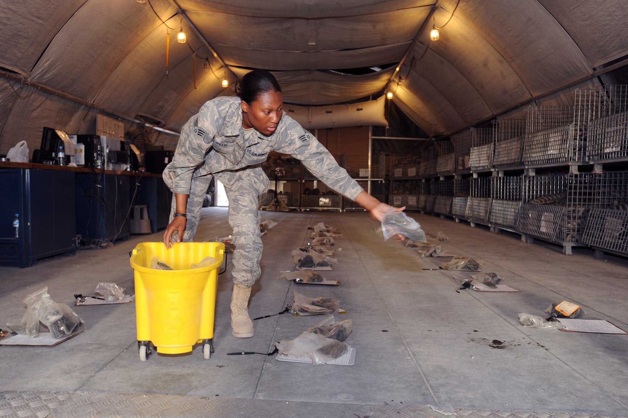 Senior Airman Lashanda Willis, a mobility specialist for the 379th Expeditionary Logistic Readiness Squadron, prepares the expeditionary theater distribution center for inbound transient personnel here, May 19, 2009, in an undisclosed location in Southwest Asia.  Attention to details during preparation and issue of equipment allows Airman Willis and fellow mobility specialists to effectively and efficiently process personnel.  Airman Willis is native to Lithonia, Ga. and is deployed from Hickam Air Force Base, Hawaii in support of Operations Iraqi and Enduring Freedom and Combined Joint Task Force - Horn of Africa.  (U.S. Air Force Photo by Staff Sgt. Joshua Garcia/released)