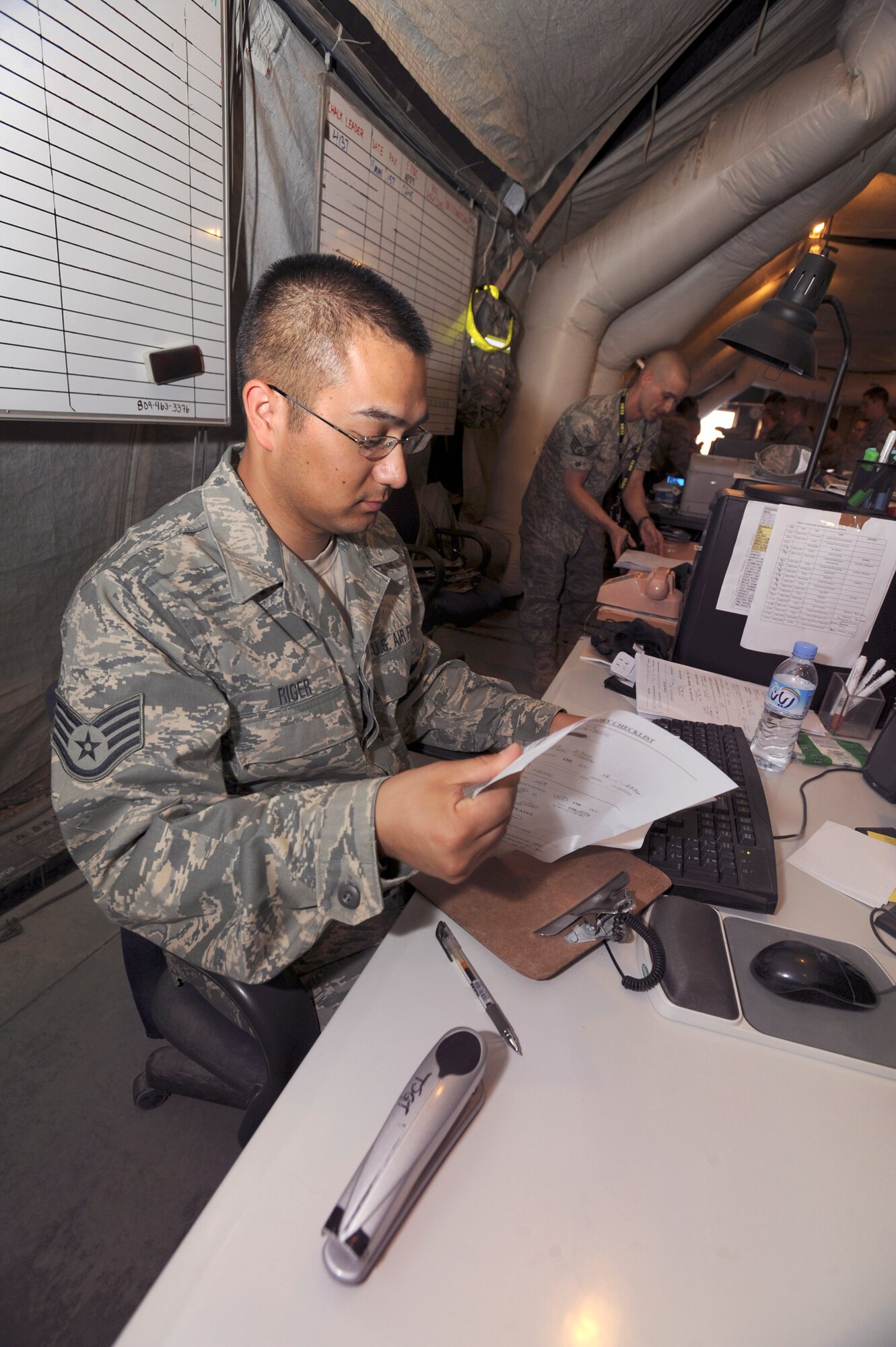 Staff Sgt. James Riger, a mobility specialist with the 379th Expeditionary Logistic Readiness Squadron, reviews the issued equipment paperwork of transient personnel here, May 19, 2009, in an undisclosed location in Southwest Asia.  The paperwork acts as a hand receipt to ensure personnel are accountable for the equipment issued to them.  Sergeant Riger is native to Reno, Nev. and is deployed from the Reno National Guard, Nev., in support of Operations Iraqi and Enduring Freedom and Combined Joint Task Force - Horn of Africa.  (U.S. Air Force Photo by Staff Sgt. Joshua Garcia/released)