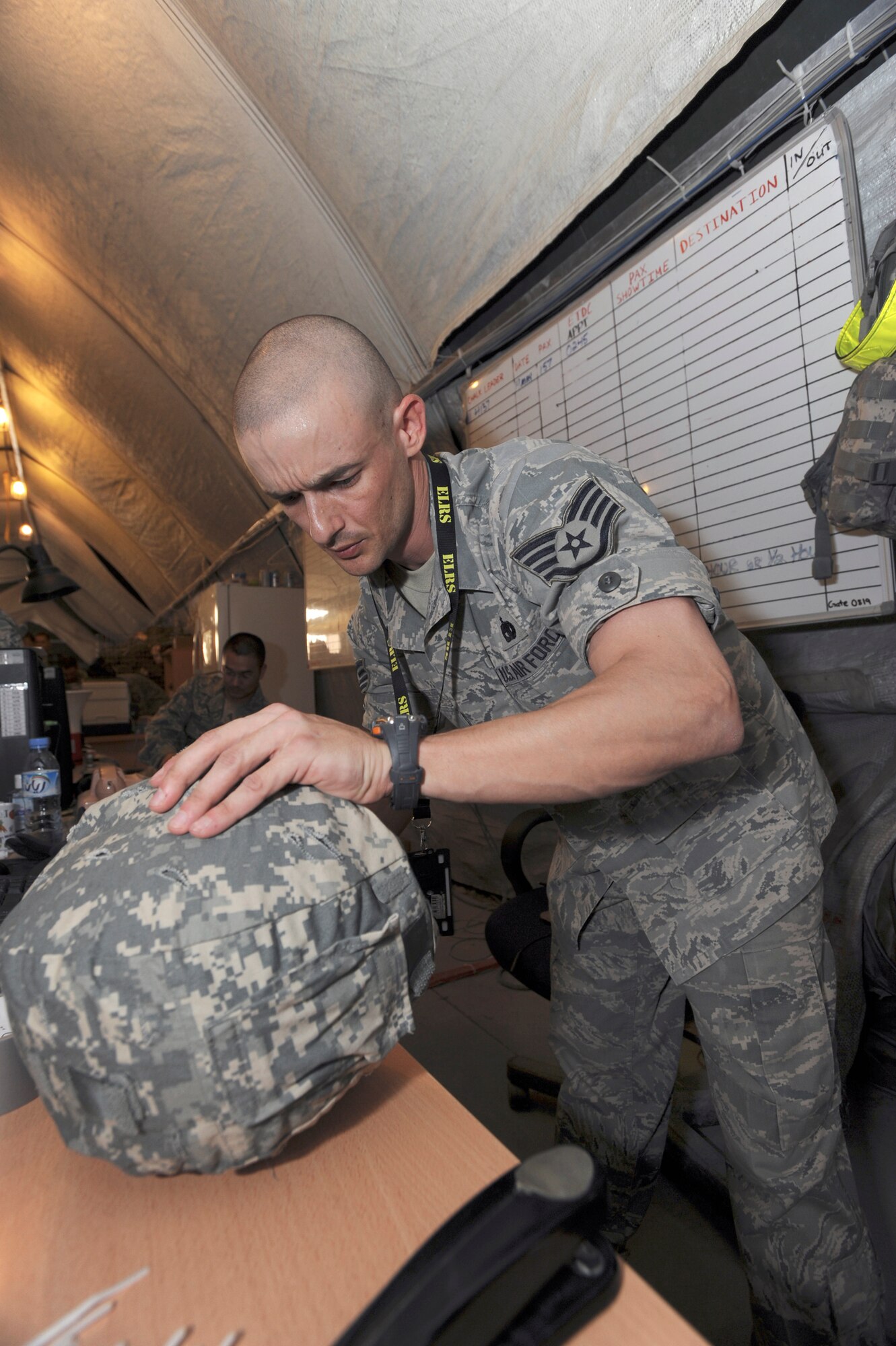 Staff Sgt. Michael Long, the non-commissioned officer in charge of the Issue Tent for the 379th Expeditionary Logistic Readiness Squadron, checks the block number of a kevlar helmet here, May 19, 2009, in an undisclosed location in Southwest Asia.  Sergeant Long and fellow mobility specialists assigned to the expeditionary theater distribution center issue all additional equipment required of Air Force personnel transiting through to other locations in the U.S. Central Command's area of responsibility.  Sergeant Long is native to Dangerfield, Texas and is deployed out of Altus Air Force Base, Okla., in support of Operations Iraqi and Enduring Freedom and Combined Joint Task Force - Horn of Africa.  (U.S. Air Force Photo by Staff Sgt. Joshua Garcia/released)