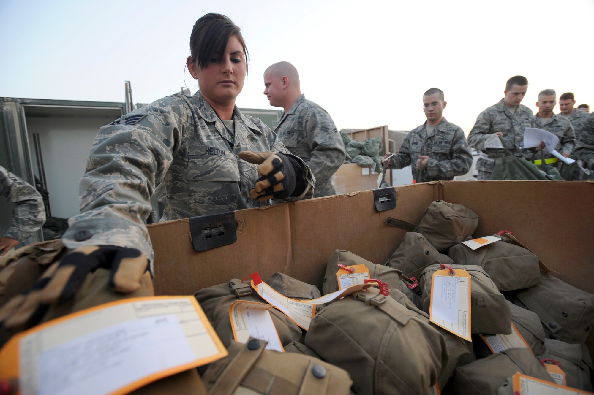 Senior Airman Kalynn Helton a mobility specialist with the 379th Expeditionary Logistic Readiness Squadron, hands transient Air Force personnel their individual first aid kits here, May 19, 2009, in an undisclosed location in Southwest Asia.  Airman Helton and fellow mobility specialists at the expeditionary theater distribution center ensure all transient and forward deploying Air Force personnel are properly equipped prior to reaching their final destination in the U.S. Central Command's area of responsibility. Airman Helton is native to Gilson, Ill. and is deployed from the Illinois Air National Guard in support of Operations Iraqi and Enduring Freedom and Combined Joint Task Force - Horn of Africa.  (U.S. Air Force Photo by Staff Sgt. Joshua Garcia/released)