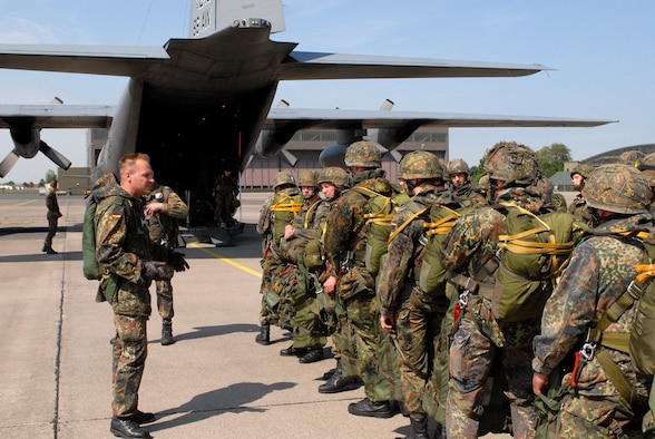 German paratroopers from the 272nd Airborne Support Battalion prepare to
board a Ramstein C-130 before a morning jump May 14 at Wunstorf Air Base,
Germany. Between two U.S. C-130s and a pair of German C-160s, 400
paratroopers were scheduled to jump through the day. Unfortunately, the jump
was cancelled for safety reasons due to high ground winds. (Photo by Capt.
John Ross)
