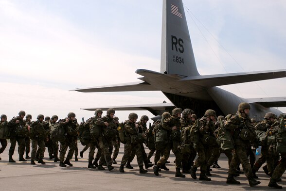 German paratroopers from the 272nd Airborne Support Battalion prepare to
board a Ramstein C-130 before a morning jump May 14 at Wunstorf Air Base,
Germany. Between two U.S. C-130s and a pair of German C-160s, 400
paratroopers were scheduled to jump through the day. Unfortunately, the jump
was cancelled for safety reasons due to high ground winds. (Photo by Capt.
John Ross)
