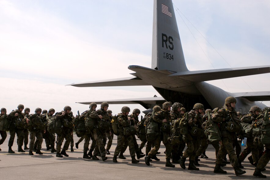 German paratroopers from the 272nd Airborne Support Battalion prepare to
board a Ramstein C-130 before a morning jump May 14 at Wunstorf Air Base,
Germany. Between two U.S. C-130s and a pair of German C-160s, 400
paratroopers were scheduled to jump through the day. Unfortunately, the jump
was cancelled for safety reasons due to high ground winds. (Photo by Capt.
John Ross)
