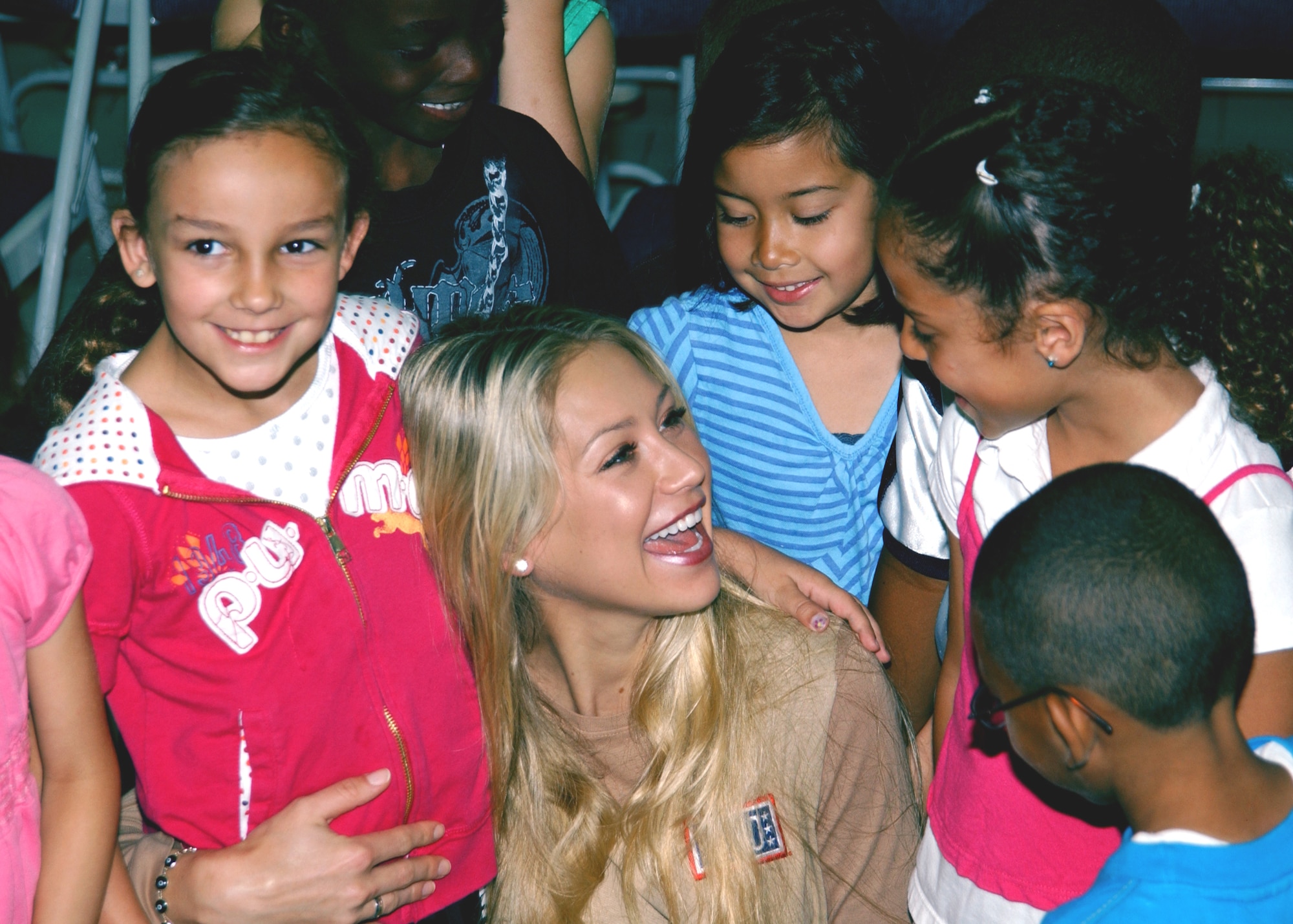 Professional athlete and model, Anna Kournikova, visits with the children of Incirlik's schools May 18.  It was just one stop during her USO visit to Incirlik AB, during which she answered student’s questions about health and fitness.  She also toured a C-17 Globemaster III and visited with the 39th Security Forces Squadron.  (U.S. Air Force photo/Staff Sgt. Chris Galindo)