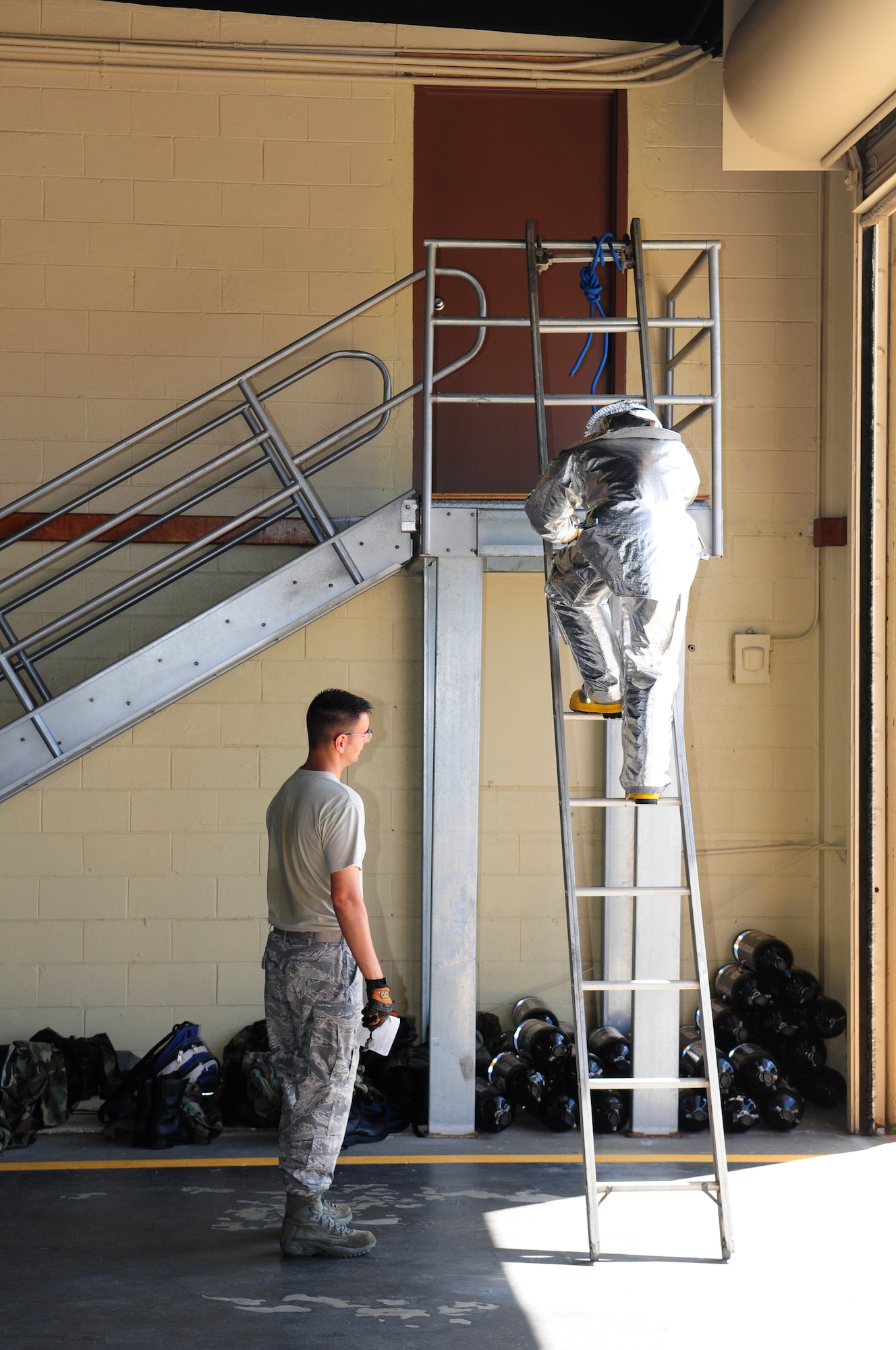 ANDERSEN AIR FORCE BASE, Guam -- Staff Sgt. Dan Flick, 36th Civil Engineer Squadron Fire Department, counts the steps as a United States Air Force Academy cadet runs up an eight-step ladder three times in a fire fighter physical training competition May 19. The fire house offered a unique perspective for the third year cadets. The cadets observed enlisted personnel in action in leadership positions. (U.S. Air Force photo by Tech. Sgt. Michael Boquette)