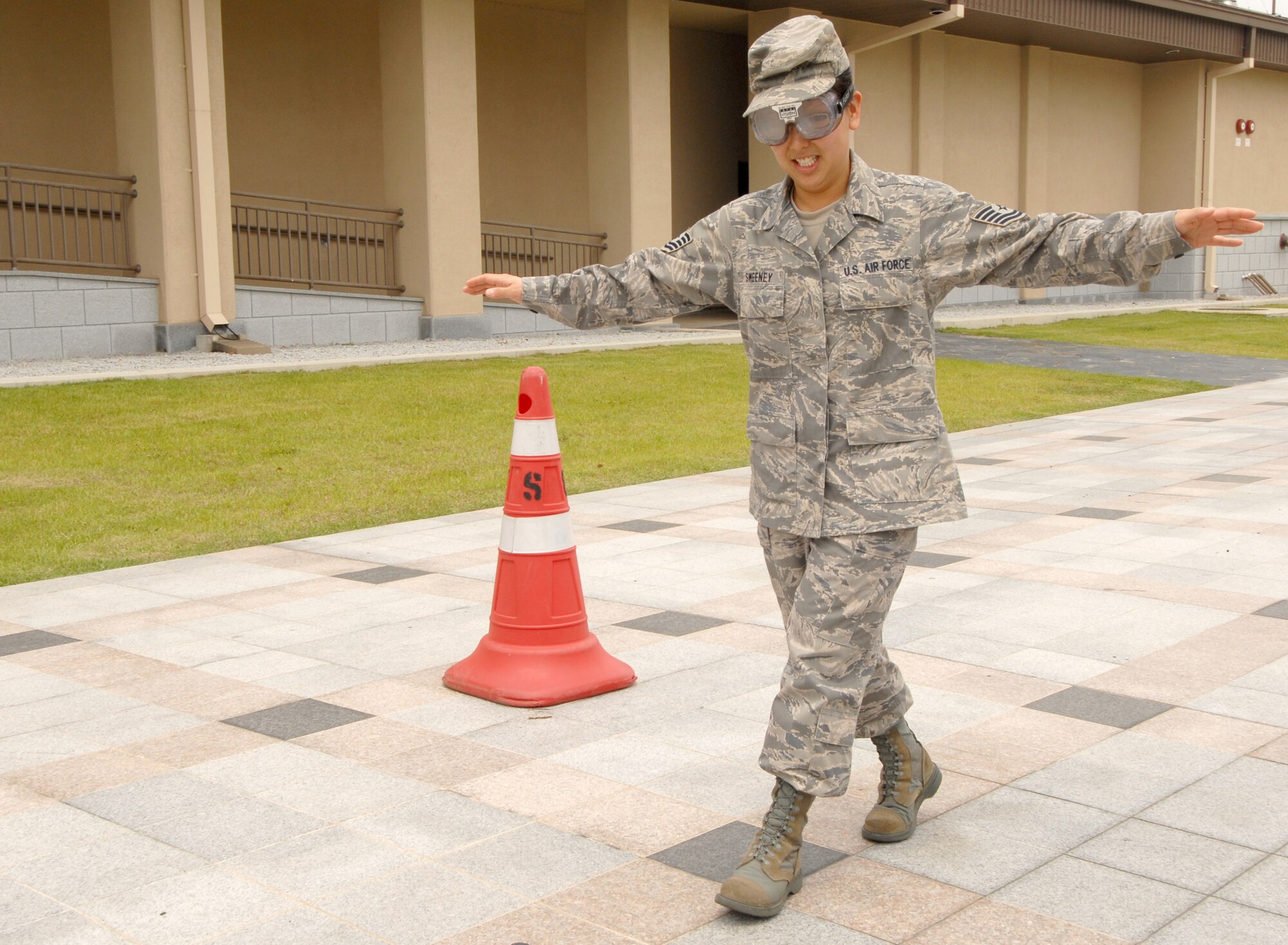 Tech. Sgt. Elizabeth Sweeney, 8th Force Support Squadron, attempts to walk wearing "drunk goggles" at Kunsan Air Base, Republic of Korea, May 20. The "drunk goggles," which simulated walking and driving under the influence, along with safety information was given out to Airmen to kick off the 101 Critical Days of Summer campaign. (U.S. Air Force Photo by Senior Airman Gustavo Gonzalez)