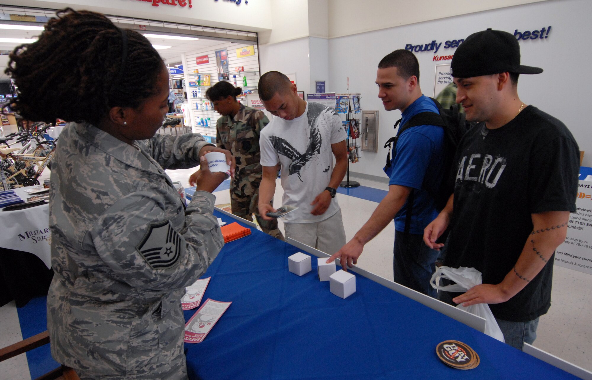 Master Sgt. Schelaundye Owens, 8th Fighter Wing, passes out safety information at Kunsan Air Base, Republic of Korea, May 20. Along with passing out safety information, Kunsan members were able to take a "drunk goggle" test to help kick off the 101 Critical Days of Summer campaign. (U.S. Air Force Photo by Senior Airman Gustavo Gonzalez)
