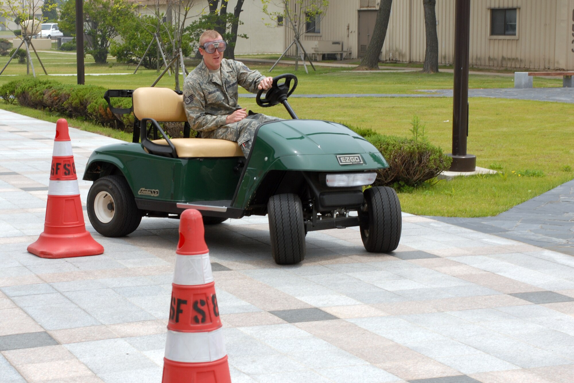 Staff Sgt. Jack MacArther, 8th Aircraft Maintenance Squadron, drives a golf cart while wearing "drunk goggles" at Kunsan Air Base, Republic of Korea, May 20. The 8th Fighter Wing Safety Office offered the "drunk goggles" event and passed out safety information to help kick off the 101 Critical Days of Summer campaign. (U.S. Air Force Photo by Senior Airman Gustavo Gonzalez)