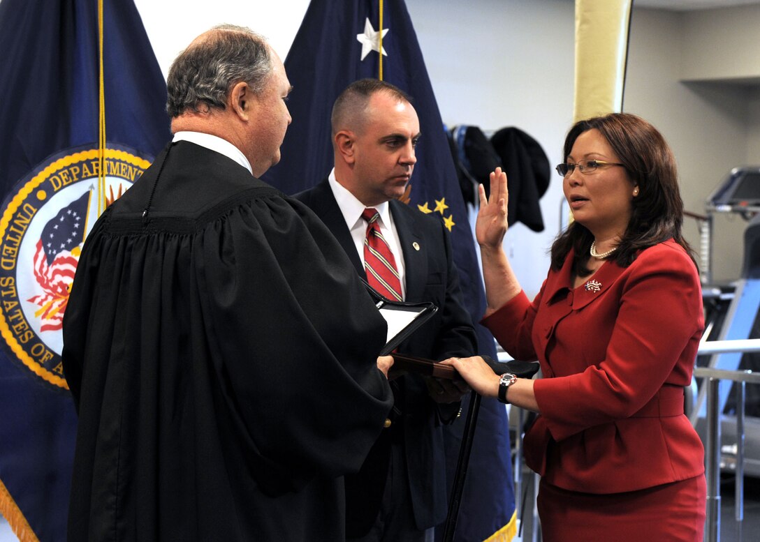 L. Tammy Duckworth, right, assistant secretary of veterans affairs for public and intergovernmental affairs, is sworn into federal office by Judge John J. Farley, left, U.S. Court of Appeals for Veterans Claims, May 20, 2009, at Walter Reed Army Medical Center in Washington, Army National Guard Maj. Bryan Bowlsbey, D.C. Duckworth’s husband, stood at her side during the ceremony. Department of Veterans Affairs photo