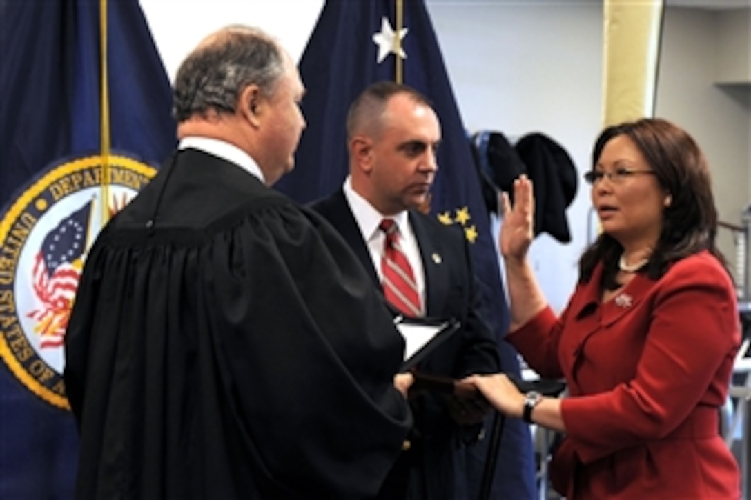 Army National Guard Maj. L. Tammy Duckworth, right, assistant Veterans Affairs secretary for public and intergovernmental affairs, is sworn into federal office by Judge John J. Farley, left, U.S. Court of Appeals for Veterans Claims, May 20, 2009, during a ceremony at Walter Reed Army Medical Center. Army National Guardsman Maj. Bryan Bowlsbey, Duckworth’s husband, stood at her side during the ceremony. 
