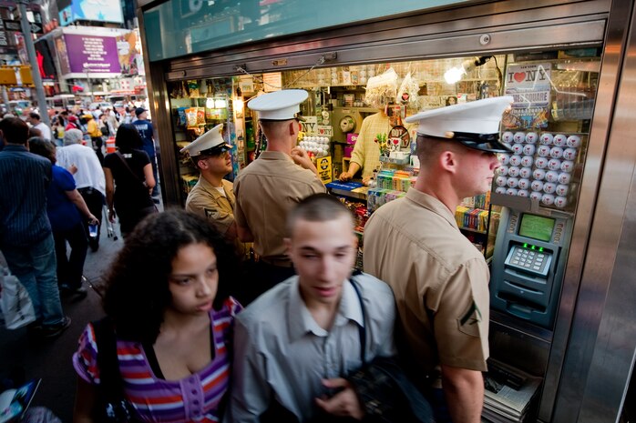 Marines visiting New York City as part of Fleet Week 2009 stop at a local street vendor to purchase a drink during a walk through Times Square, May 20.
