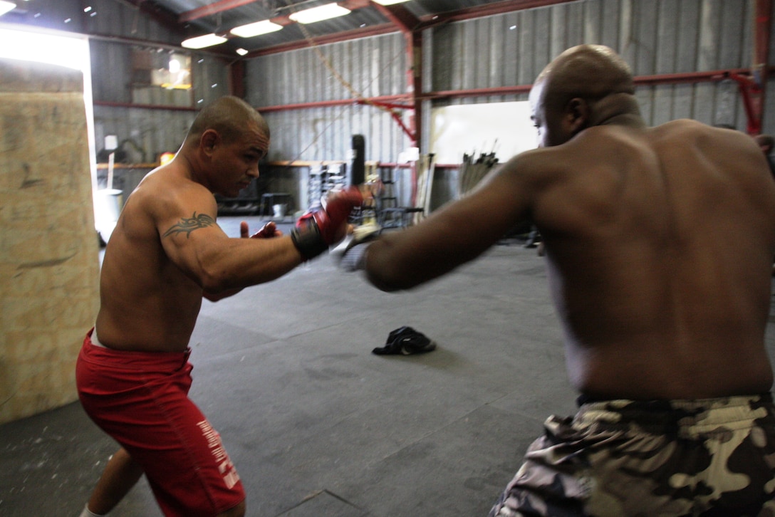 James Clark and Omar Askew, two of the Fight Club 29 warriors who took home gold medals Saturday, practice sparring in preparation for their next tournament in San Bernardino, Calif.,  June 13.