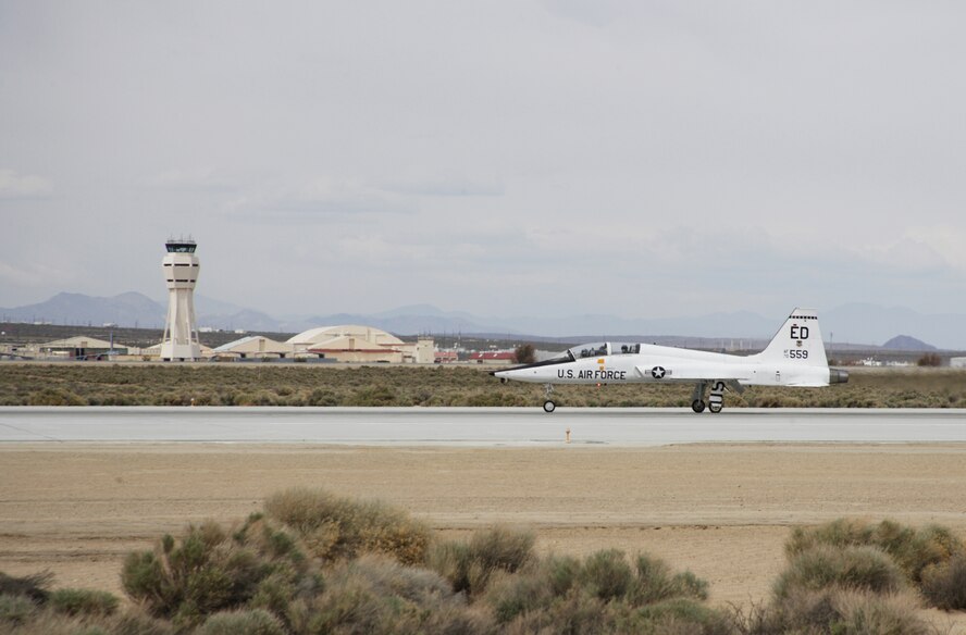 A T-38 Talon, like the one landing on an Edwards Air Force Base, Calif., runway April 10, crashed May 21 about nine miles north of the base. The aircraft and its two-person crew were on a flight-test training mission at the time of the accident. The T-38 is a twin-engine, high-altitude, supersonic jet trainer used in a variety of roles because of its design, economy of operations, ease of maintenance and high performance. (Air Force photo by Jet Fabara) 
