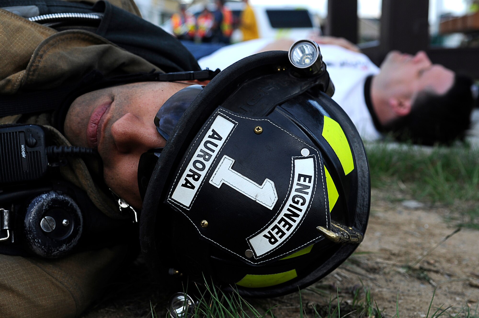 BUCKLEY AIR FORCE BASE, Colo. -- A member of the Aurora Fire Department plays dead during the Vigilant Front Range exercise here, May 15. Buckley and Aurora fire departments responded to housing after a mock fuel-tanker truck exploded at a mock wedding in Buckley Family Housing. The exercise involved federal, state and local agencies working with base agencies to test plans and build understanding, trust and relationships essential in the fast-paced environment of major disasters. (U.S. Air Force photo by Tech. Sgt. Jeromy Cross)