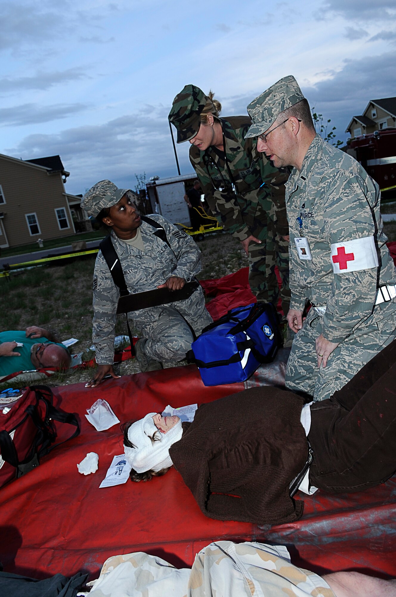 BUCKLEY AIR FORCE BASE, Colo. -- Airmen from the 460th Medical Group respond to Buckley Family Housing after a mock fuel-tanker truck exploded at a mock wedding, May 15, in support of the Vigilant Front Range exercise. The exercise involved federal, state and local agencies working with base agencies to test plans and build understanding, trust and relationships essential in the fast-paced environment of major disasters.  (U.S. Air Force photo by Tech. Sgt. Jeromy Cross)