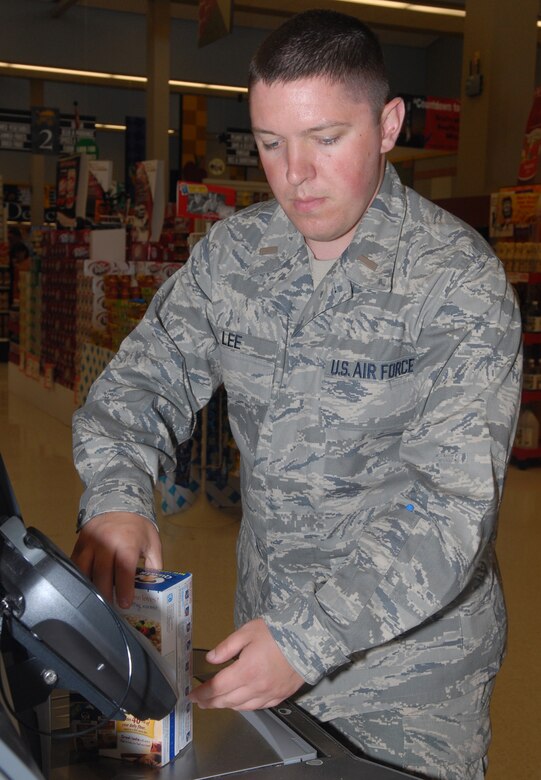 VANDENBERG AIR FORCE BASE, Calif. -- At the self check-out counter, 1st Lt. Nathaniel Lee scans his items at the Vandenberg Commissary here May 19. A recent survey shows the commissary saves customers up to $3,400. (U.S. Air Force photo/Airman 1st Class Antoinette Lyons) 
