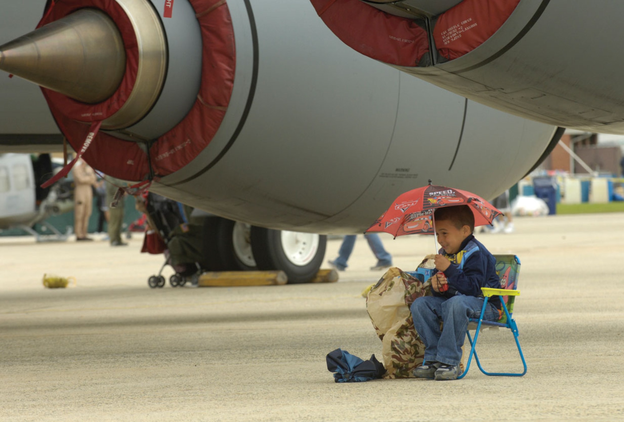 A young boy shields himself from the wind and rain as he watches the U.S. Air Force Thunderbirds perform during the 2009 JSOH May 17 at Andrews. (U.S. Air Force photo/ Senior Airman Renae Kleckner)