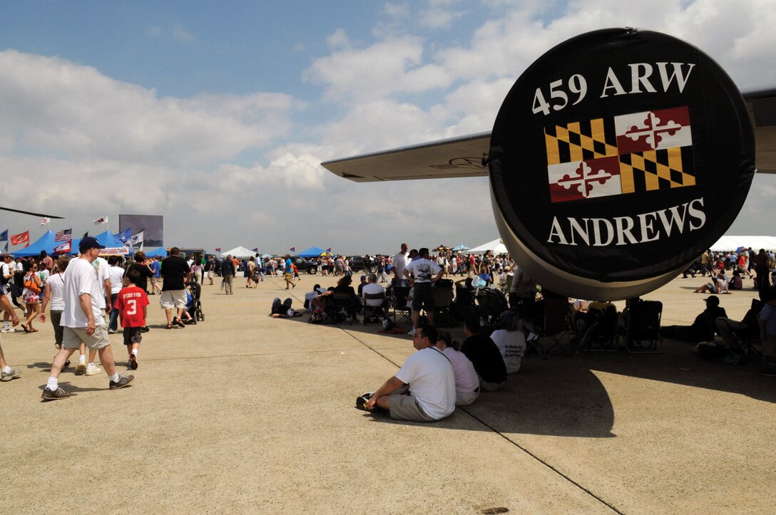 Members of the public cool off in shade provided by the wing of a 459th Air Refueling Wing KC-135R during the 2009 JSOH May 16. JSOH is a combined effort, reflective of the collaborative nature of protecting and defending America's security. (U.S. Air Force photo/ Staff Sgt. Dan DeCook)