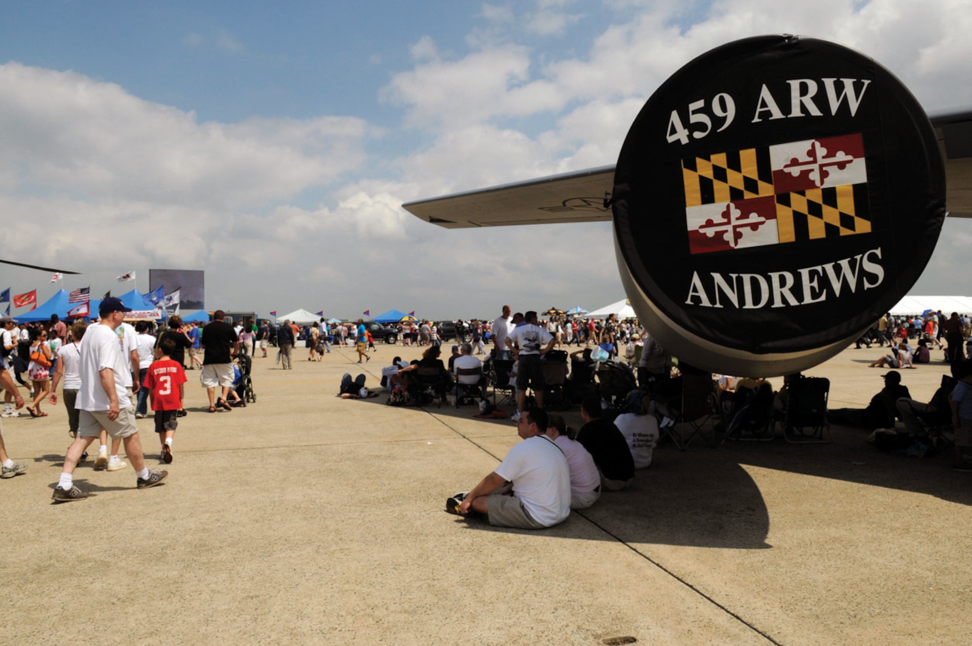 Members of the public cool off in shade provided by the wing of a 459th Air Refueling Wing KC-135R during the 2009 JSOH May 16. JSOH is a combined effort, reflective of the collaborative nature of protecting and defending America's security. (U.S. Air Force photo/ Staff Sgt. Dan DeCook)