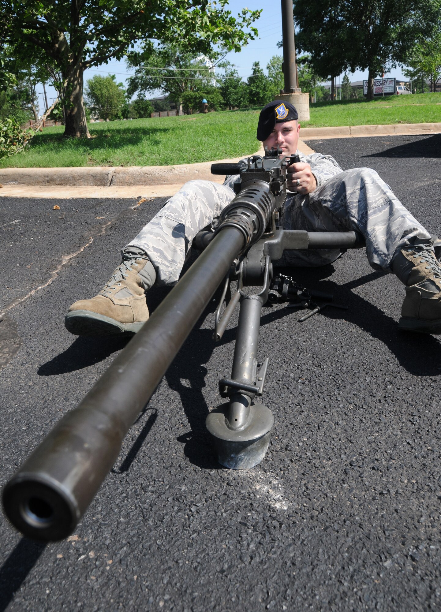 ALTUS AIR FORCE BASE, Okla --- Staff Sgt.  Matthew Treadwell, from the 97th Security Forces Squadron, simulates the use of an M-2 (50 cal) for police week at the Base Exchange parking lot on 13 May. This is the primary weapon used when traveling on convoy, and has an extremely long firing range.  (U.S. Air Force photo by Senior Airmen Cherice Bryant)
