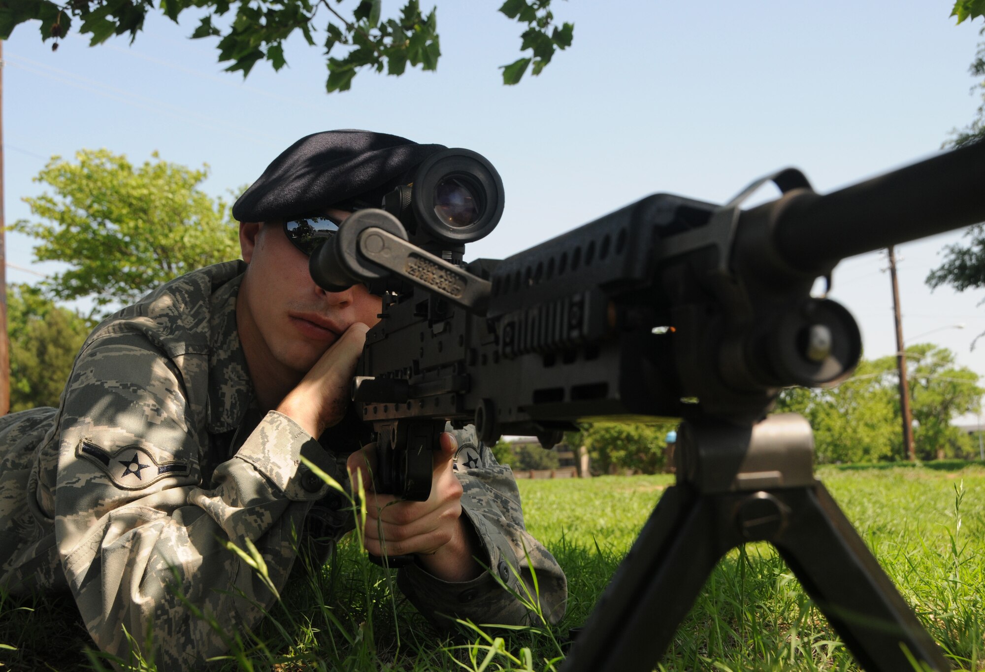 ALTUS AIR FORCE BASE, Okla ---

Airman Timothy Roberts, from the 97th Security Forces Squadron, simulates the use of an m-249 SAW AR (automatic rifle) during a vehicle and weapon demonstration for police week at the Base Exchange parking lot on 13 May.  This weapon is used for suppressive firing toward light armor vehicles, and has the capacity to fire a maximum of 900 rounds per minute. 
(U.S. Air Force photo by  Senior Airman Cherice Bryant)
