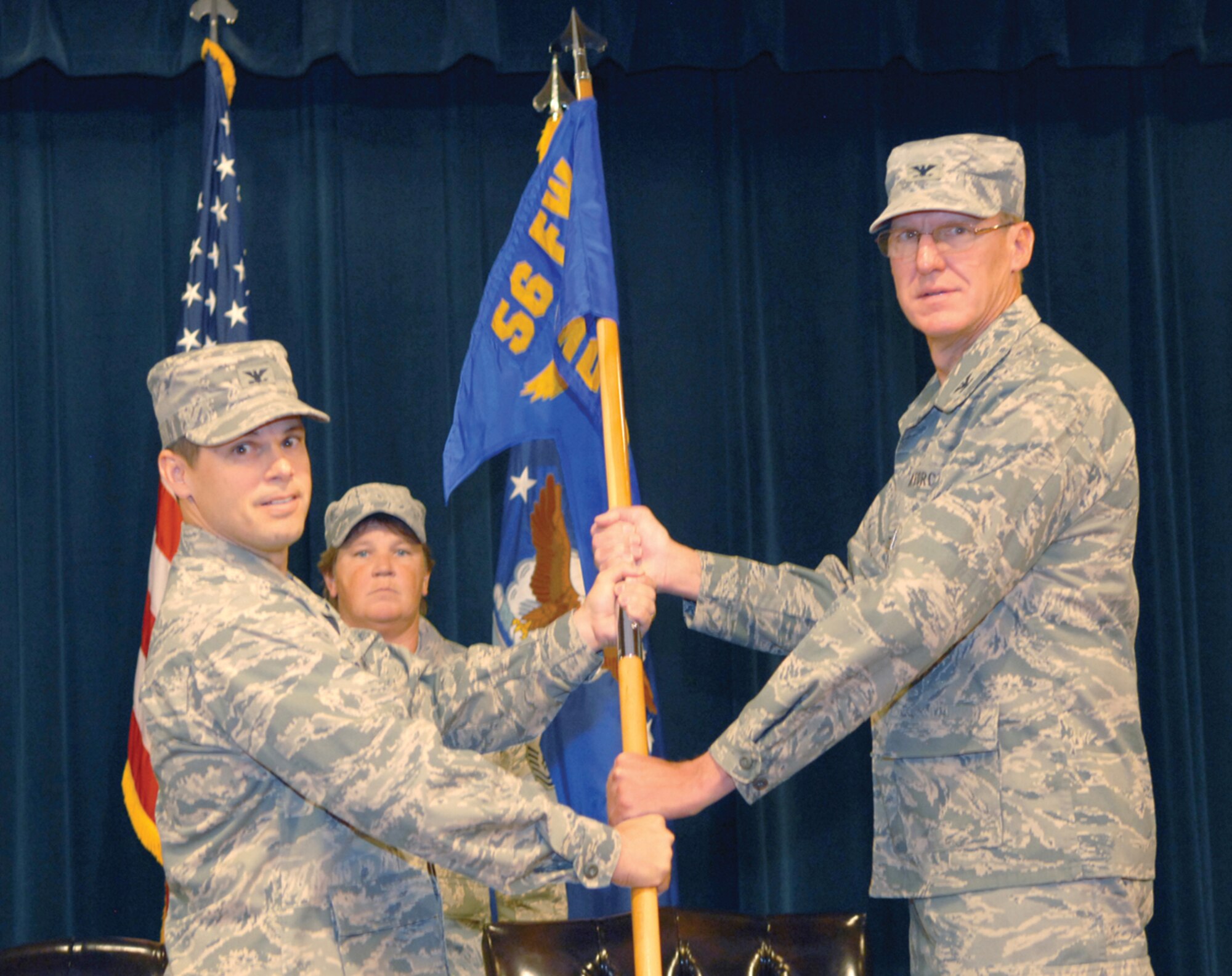 Col. David Hall accepts command of the 56th Medical Operations Squadron from Col. Mark Holland, 56th Medical Group commander, Wednesday at the Desert Star Club. (U.S. Air Force photo/ Airman 1st Class Sandra Welch)