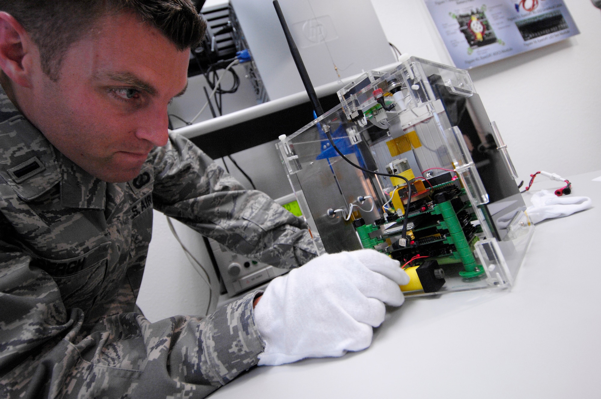 VANDENBERG AIR FORCE BASE, Calif. -- Concentrating on the task at hand, 1st Lt. Randall Bergh, a 392nd Training Squadron student, inspects the circuit boards of an EyasSat training module during a laboratory exercise here May 19. The EyasSat module is a major satellite subsystem designed to give students the hands-on experience they need to conduct successful satellite space operations for the Air Force. (U.S. Air Force photo/Senior Airman Matthew Plew)
