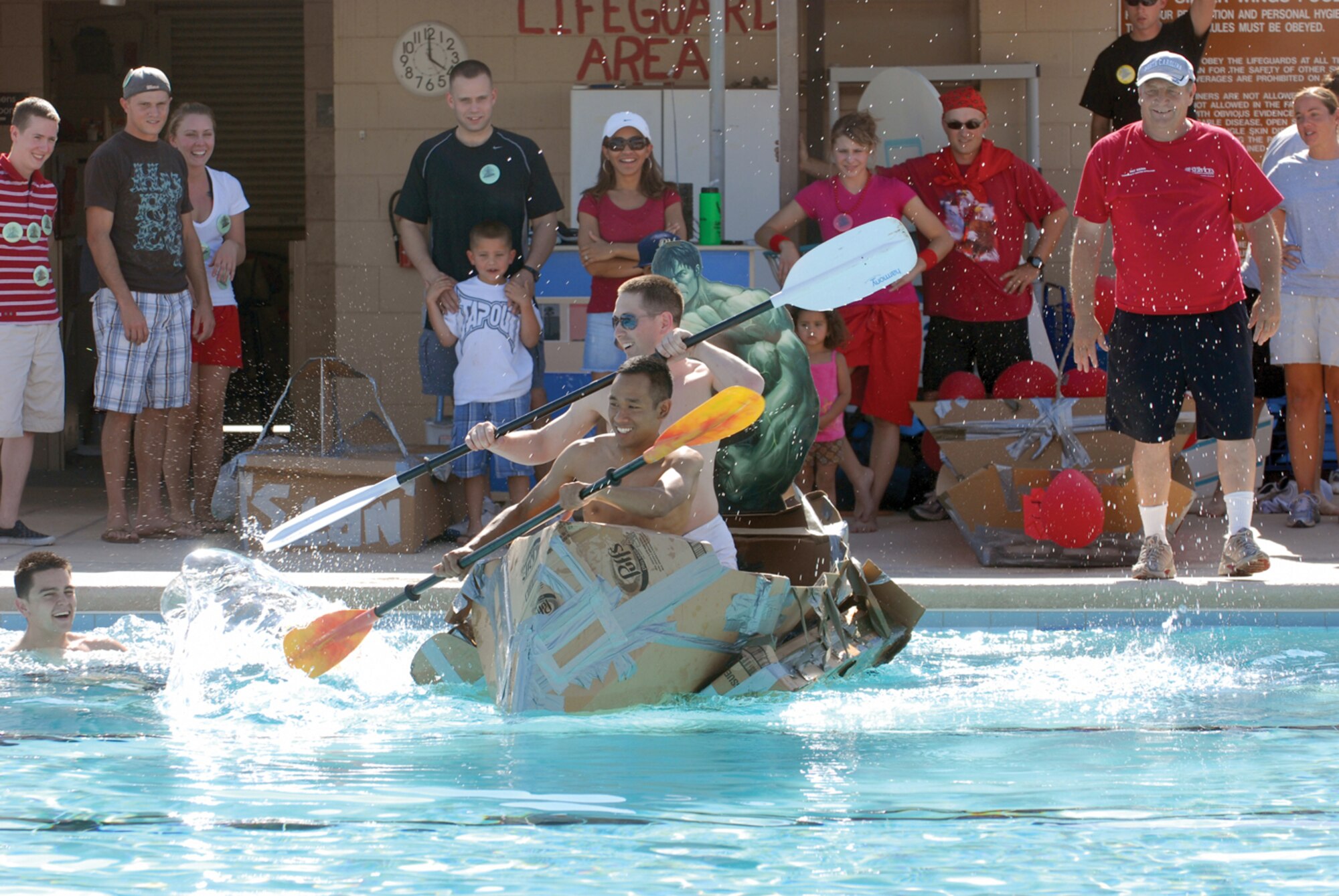 Staff Sgts. Norindeth Dek and Joshua Preston, 56th Component Maintenance Squadron precision measurement equipment laboratory specialists, participate in a boat race during the Wacky Olympics May 15 at Silver Wings Pool. (U.S. Air Force photo/ Airman 1st Class Sandra Welch)