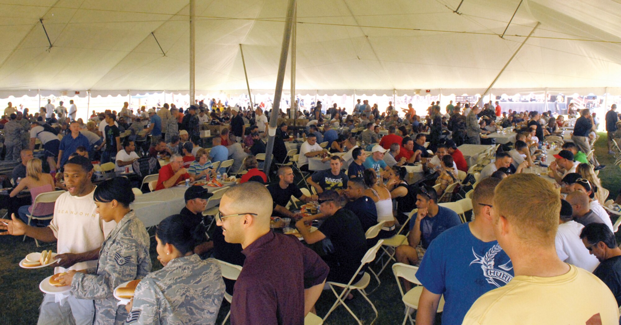 Luke members crowd into the tent where food is served. The Luke Air Force Base 56th Force Support Squadron hosted a base picnic including a barbecue, Wacky Olympics and Family Funlympics.   (U.S. Air Force photo/ Airman 1st Class Sandra Welch)