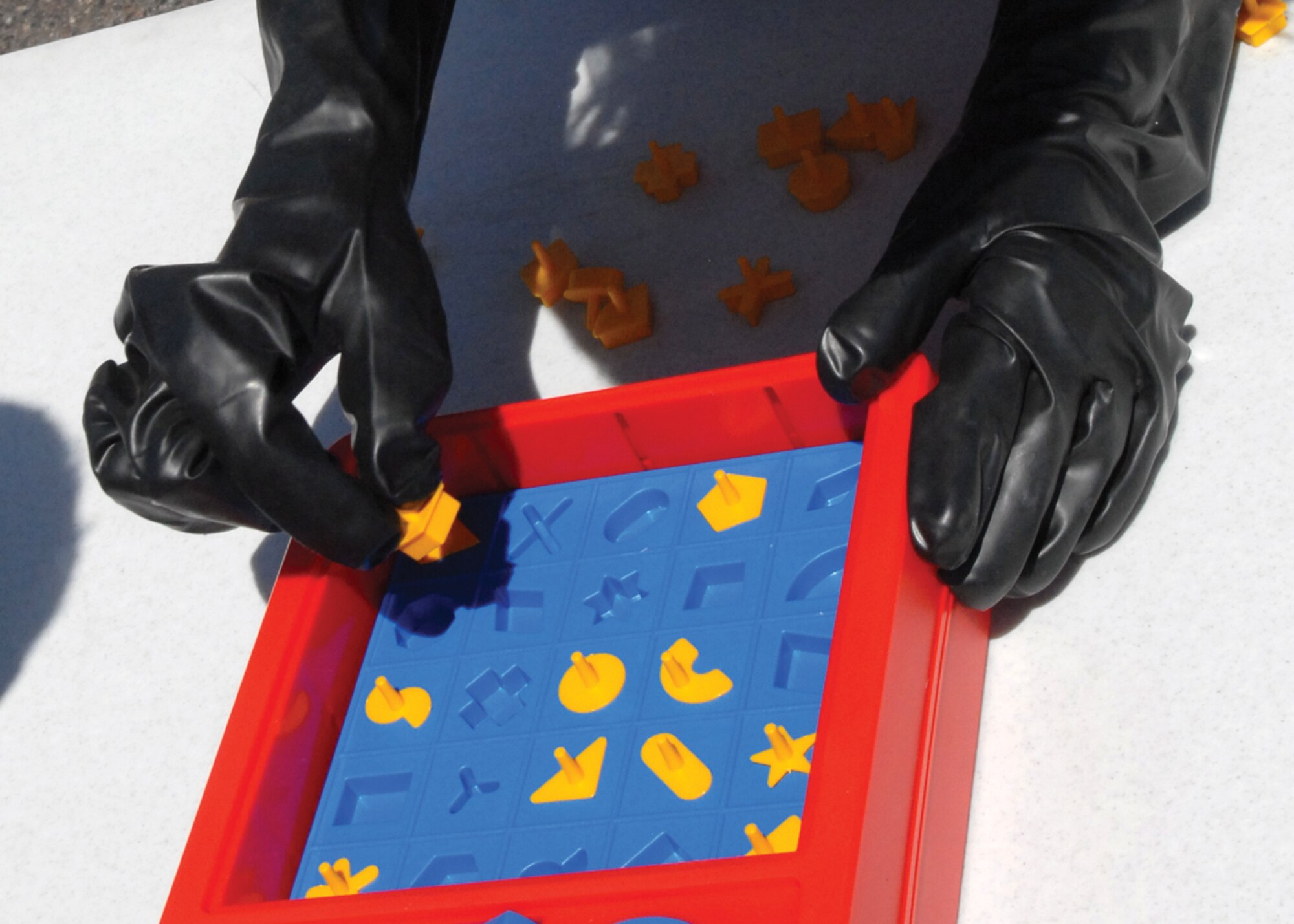 Airman 1st Class Shardai Johnson, 56th Component Maintenance Squadron precision measurement equipment laboratory specialist, plays the board game Perfection as part of the bed race at the base picnic.  (U.S. Air Force photo/ Airman 1st Class Sandra Welch)