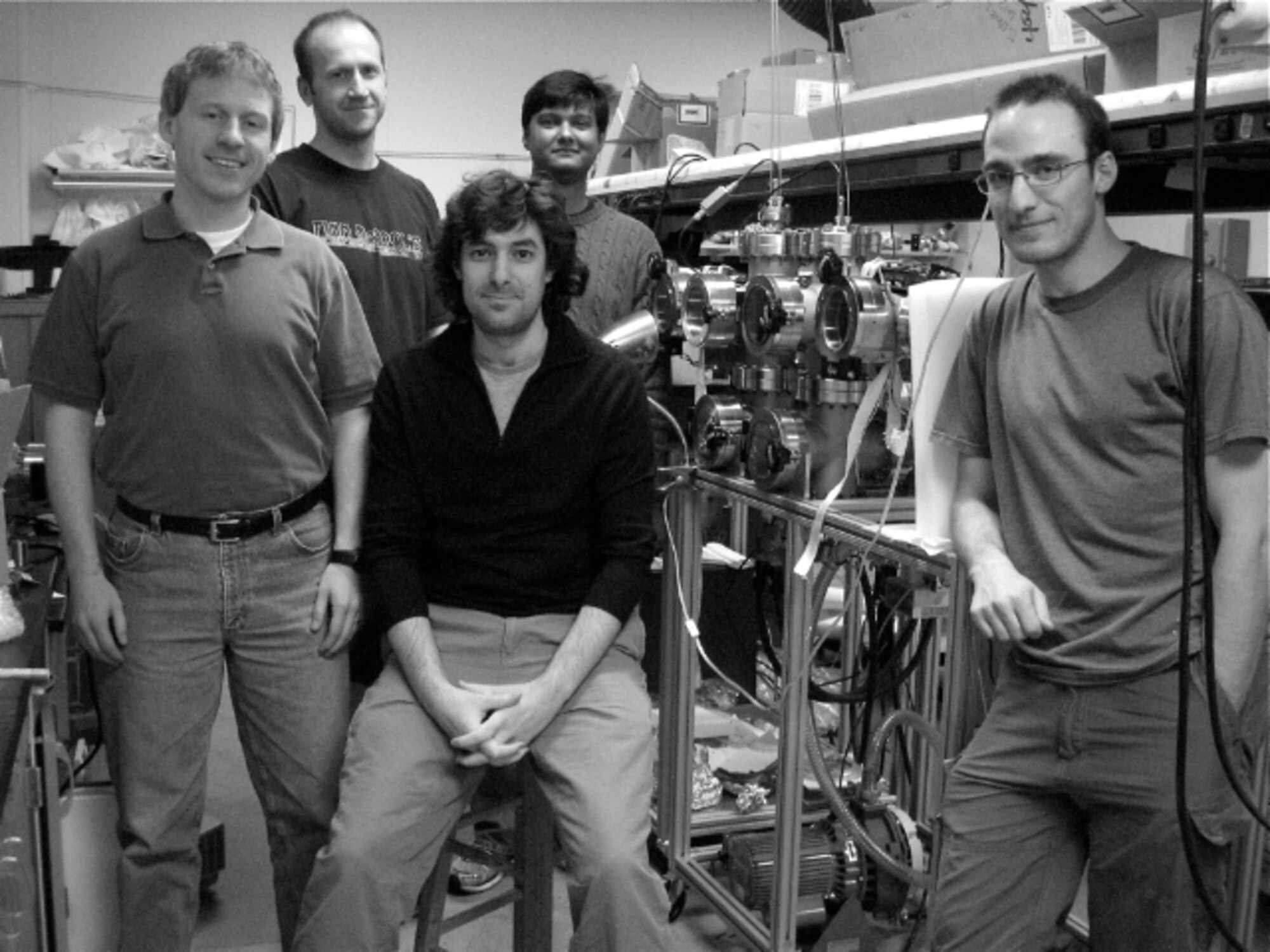 With AFOSR funding, a team from the University of Michigan is working on a project to integrate solar power cheaply and easily into the base materials used to build UAVs. The team is pictured above posing around a customized reel-to-reel coating apparatus they developed for making large quantities of fiber-based energy conversion devices. 

(Center) Max Shtein, an assistant professor working on optoelectronic materials and devices, thin-film processing 

(Left to Right) Kevin Pipe, an assistant professor working on thermal phenomena in materials and devices; Brendan O'Connor, a graduate student working on organic solar cells on fibers; Abhishek Yadav, a graduate student working on thermoelectric devices on fibers; and Steven Morris, a graduate student working on reel-to-reel deposition of films and devices on fibers.

(Photo Credit: University of Michigan)