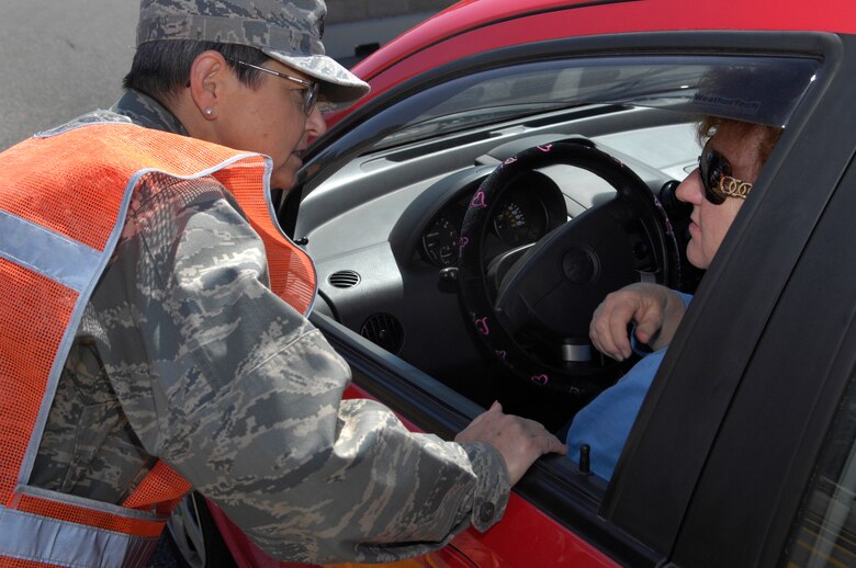 VANDENBERG AIR FORCE BASE, Calif. --  Lt. Col. Judy Gavin, the chief nurse of the 30th Medical Operations Squadron, stops a driver exiting the Santa Maria Gate to ensure she is wearing a seat belt here May 21.The 101 Critical Days of Summer kicked off May 20. All of Team V is reminded to remain safe and use common sense when it comes to traveling and participating in outdoor activities.   (U.S. Air Force photo/Airman 1st Class Andrew Lee) 