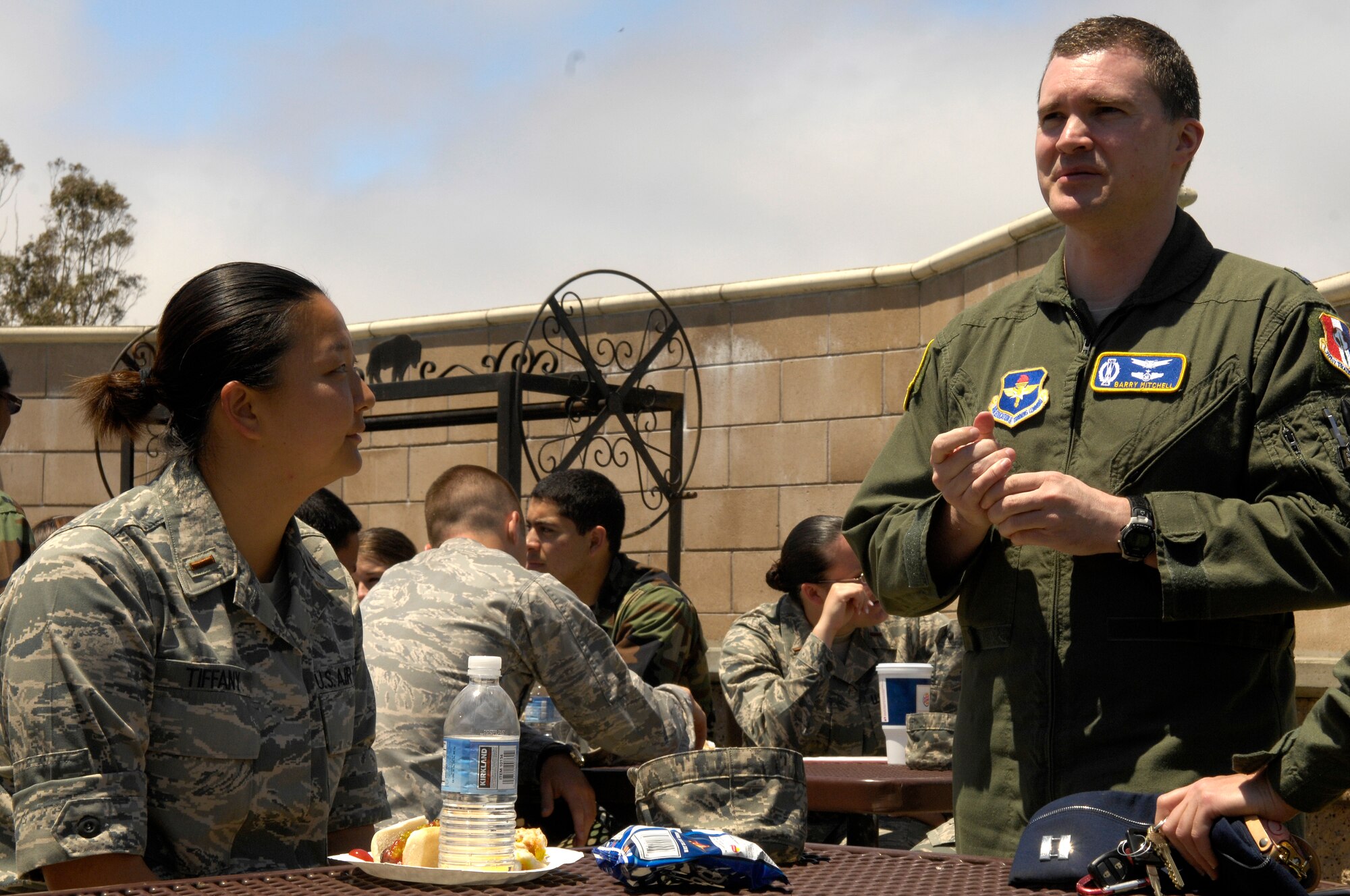 VANDENBERG AIR FORCE BASE, Calif. -- Learing from a professional, 2nd Lt. Jessie Tiffany, a Space 100 student with the 392nd Training Squadron, receives career advice from 381st Training Group instructor Capt. Barry Mitchell about her new assignment to Malmstrom AFB, Mont., during a squadron burger burn here May 19. The cookout is traditionally held for students after they receive their new assignments.(U.S. Air Force photo/Senior Airman Matthew Plew)