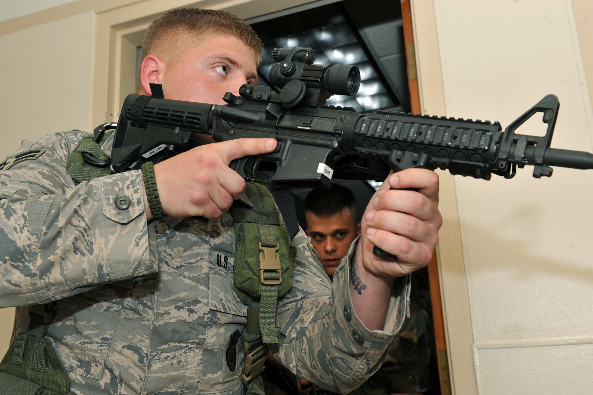 OFFUTT AIR FORCE BASE, Neb. -- Airman 1st Class Matthew Hobbs and Senior Airman Sean Miller, both from the 55th Security Forces Squadron, conduct a search during a critical incident exercise inside the Martin Bomber Building here May 13. Joint training exercises such as this are common to ensure continuity between Offutt and local community first responders during a crisis situation.  U.S. Air Force Photo By Charles Haymond.