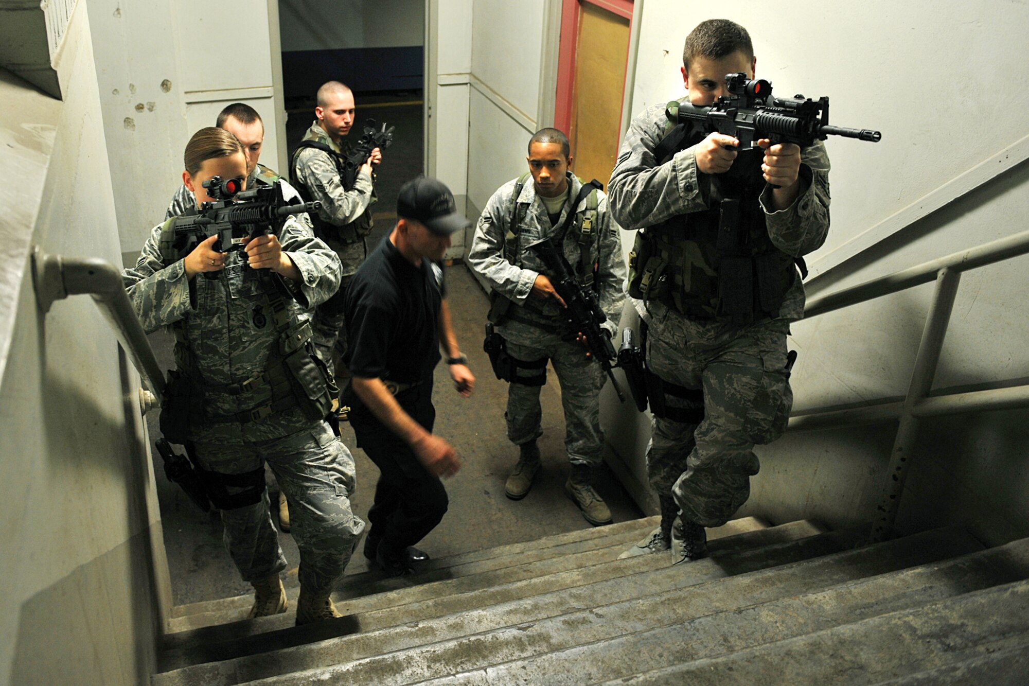 OFFUTT AIR FORCE BASE, Neb. -- Sergeant Robert Wondra, Omaha Police Department, instructs members of the 55th Security Forces Squadron on proper response during a critical incident exercise inside the Martin Bomber Building here May 13. Joint training exercises such as this are common to ensure continuity between Offutt and local community first responders during a crisis situation.  U.S. Air Force Photo By Charles Haymond.