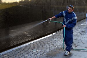 LANGLEY AIR FORCE BASE, Va. -- Airman 1st Class Jordan Tompkins, 71st Fighter Squadron crew chief, sprays the Vietnam Wall Memorial in Washington, D.C., May 19 in support of the Air Force Sergeant Associations annual effort to honor those who have perished in the line of duty. (U.S. Air Force photo/Airman 1st Class Jarrod R. Chavana)