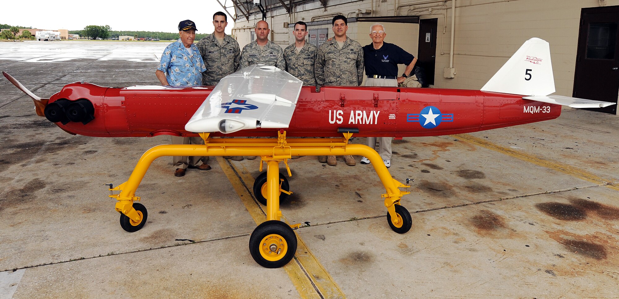 AVON PARK AIR FORCE RANGE, Fla. -- (Left to right) Retired Capt. Louis Brough, Airmen from the 23rd Equipment Maintenance Squadron, Moody Air Force Base, Ga., and retired Col. Roy Whitton, pose in front of a Radio Plane OQ-19D (KD-2R3) Target Drone at Avon Park Air Force Range, Fla., May 18. Airmen from the 23rd EMS restored the drone so that it could be displayed at Avon Park. U.S. Air Force photo by Airman Joshua Green)
