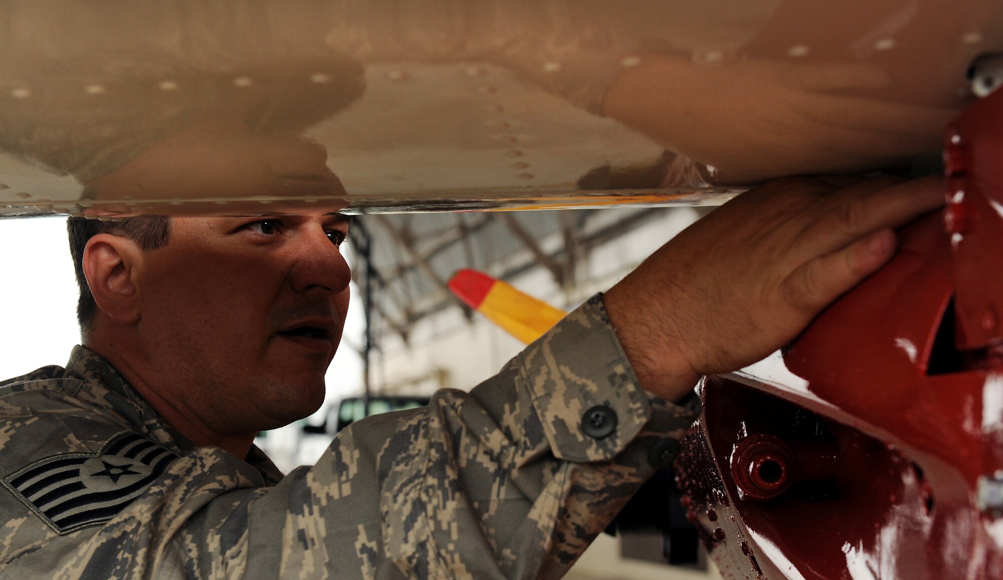 AVON PARK AIR FORCE RANGE, Fla. -- Tech. Sgt. Paul Bartels, 23rd Equipment Maintenance Squadron aircraft structural repairman, Moody Air Force Base, Ga., tightens bolts while attaching the wings to a Radio Plane OQ-19D (KD-2R3) Target Drone at Avon Park Air Force Range, Fla., May 18. Airmen from the 23rd EMS received the request to restore the drone in September 2008 and completed the restoration project in May. U.S. Air Force photo by Airman 1st Class Joshua Green) 
