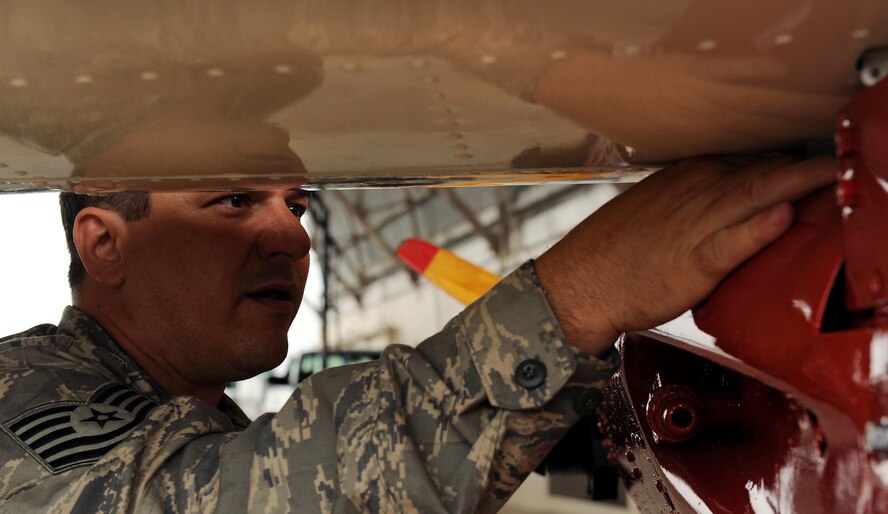 AVON PARK AIR FORCE RANGE, Fla. -- Tech. Sgt. Paul Bartels, 23rd Equipment Maintenance Squadron aircraft structural repairman, Moody Air Force Base, Ga., tightens bolts while attaching the wings to a Radio Plane OQ-19D (KD-2R3) Target Drone at Avon Park Air Force Range, Fla., May 18. Airmen from the 23rd EMS received the request to restore the drone in September 2008 and completed the restoration project in May. U.S. Air Force photo by Airman 1st Class Joshua Green) 

