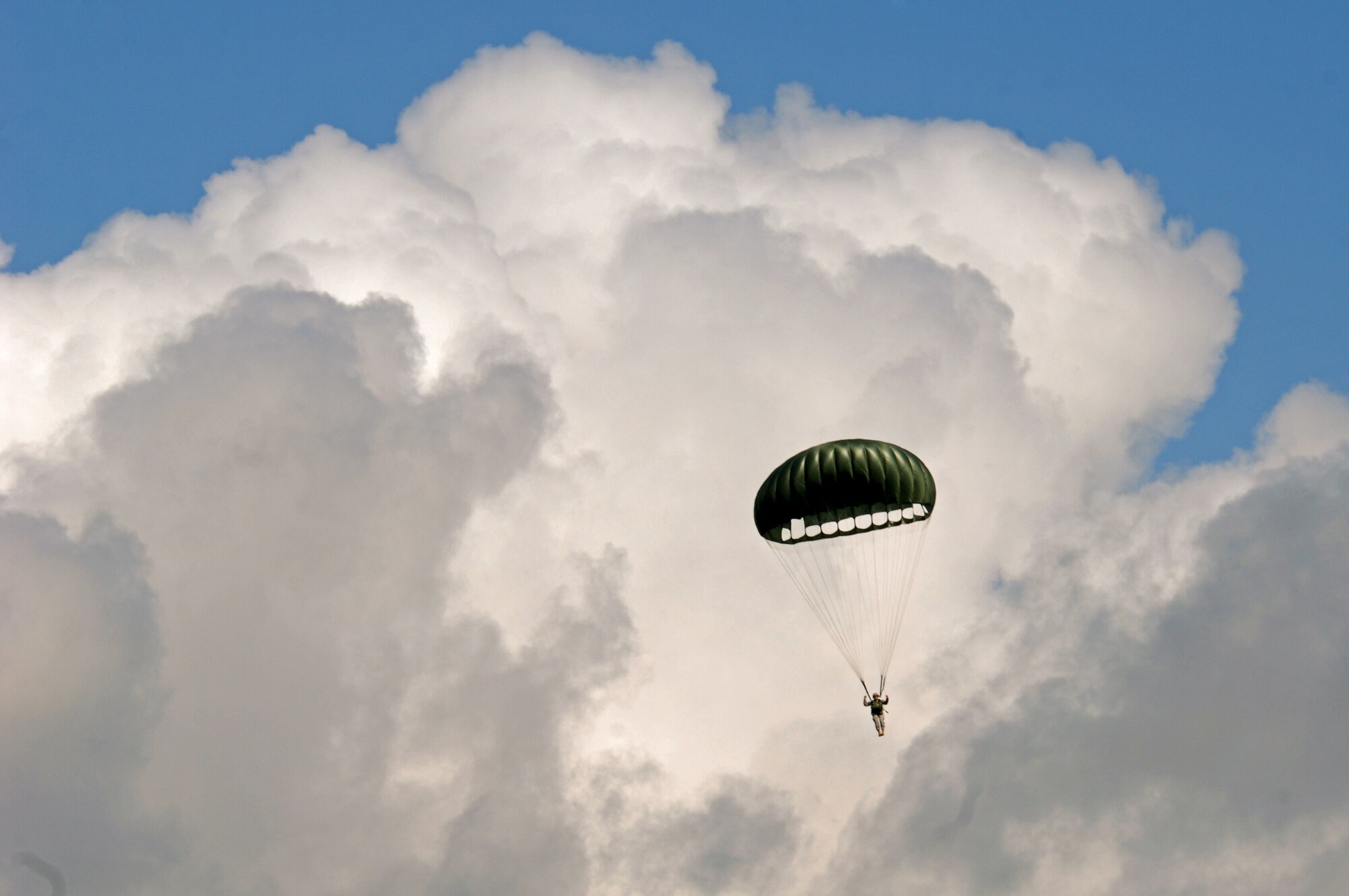 United States Air Force Senior Master Sgt. John Storms, 786th Security Forces Squadron paratrooper, glides to the ground after jumping from a C-130 Hercules as a part of an airfield assessment team during an Operational Readiness Exercise, May 20, 2009, West Freugh Airfield, Scotland. (U.S. Air Force photo by Senior Airman Kenny Holston)
