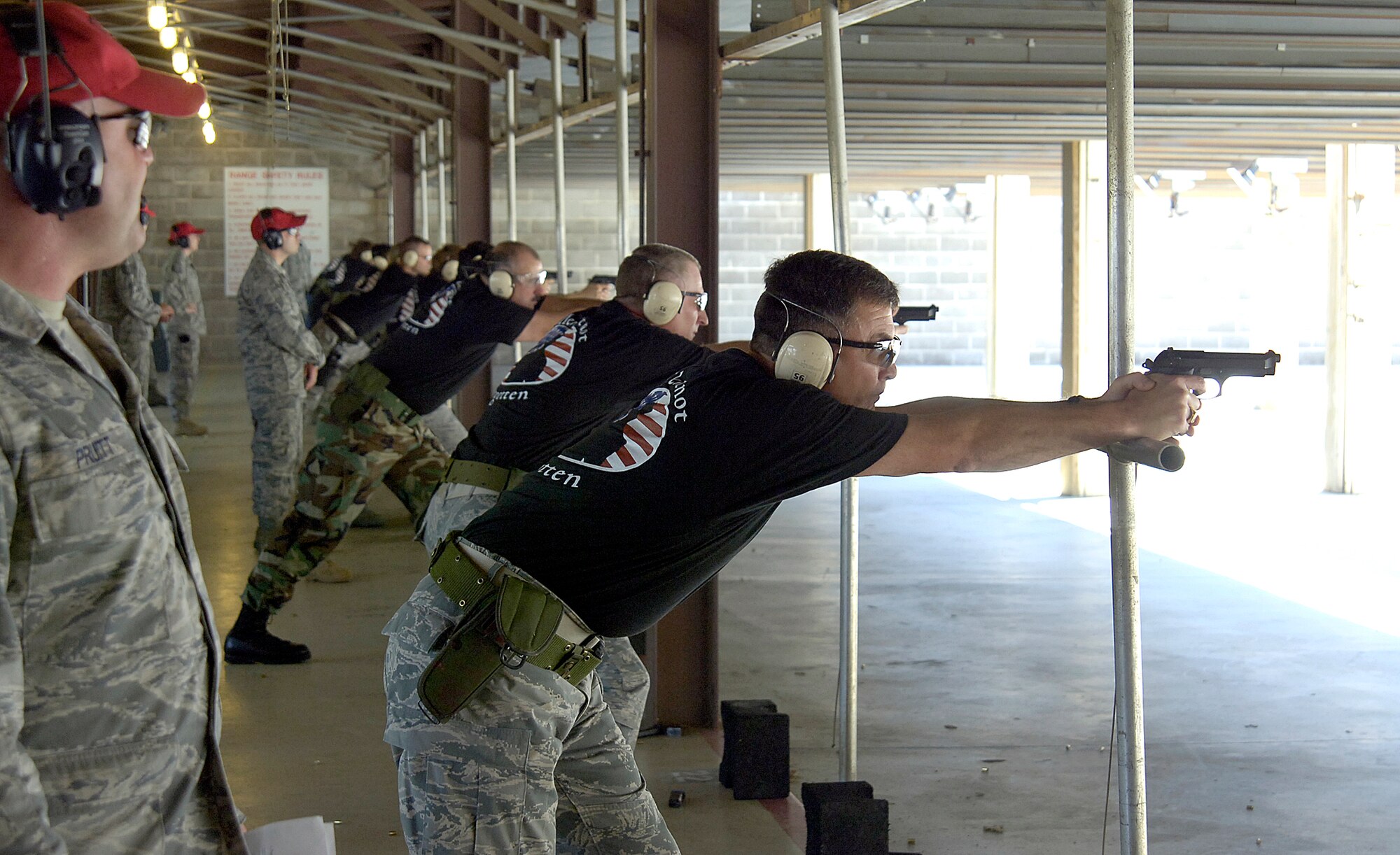 Chief Master Sgt. James Foltz, command chief of the 552nd Air Control Wing, takes aim at the 72nd Security Forces Combat Arms Range with other chief master sergeants in a command competition shootout May 13 during Tinker’s recognition of National Police Week.  Commanders, chief master sergeants and first sergeants battled for bragging rights with team awards going to the first sergeants for first, commanders for second and the chiefs taking third.  Individual awards went to Chief Master Sgt. Jackie Green, 552nd Operations Group for first; Master Sgt. Joseph Brooks, 552nd Aircraft Maintenance Squadron for second and third place going to Master Sgt. Troy Rausch, 349th Recruiting Squadron. Police Week began May 11 and included a reveille ceremony, weapons display and military working dog demonstration at the base exchange.  A run, golf tournament, bowling tournament and a memorial/retreat ceremony honoring all fallen civilian and military law enforcement officers filled the week. (Air Force photo/Margo Wright)