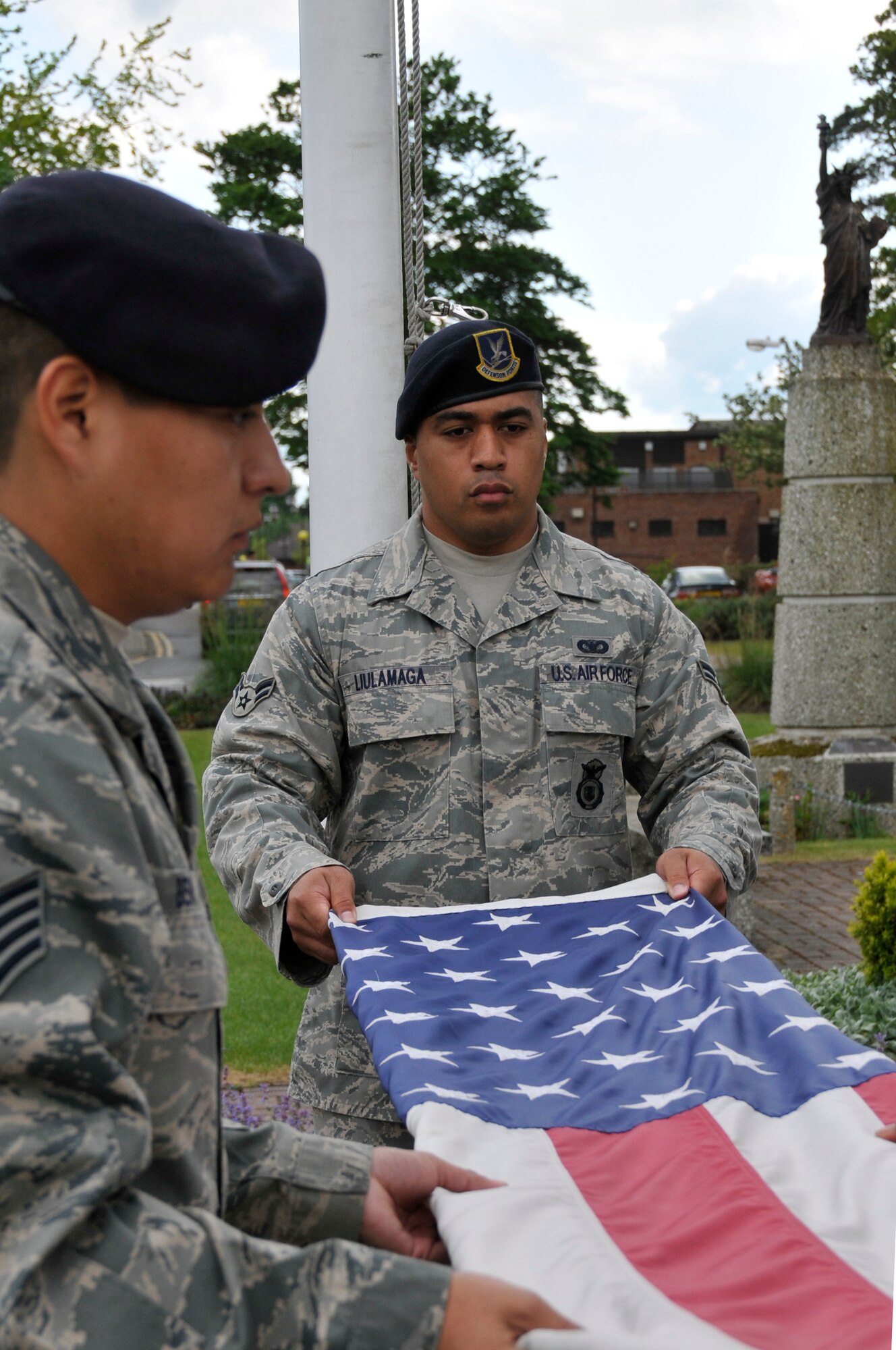 Staff Sgt. Laren Begay and Airman 1st Class Misinimese Liulamaga, 48th Security Forces Squadron patrolmen, hold the American flag during a retreat ceremony May 15, 2009 at Royal Air Force Lakenheath, England in honor of National Police Week. (U.S. Air Force photo by Airman 1st Class Perry Aston)