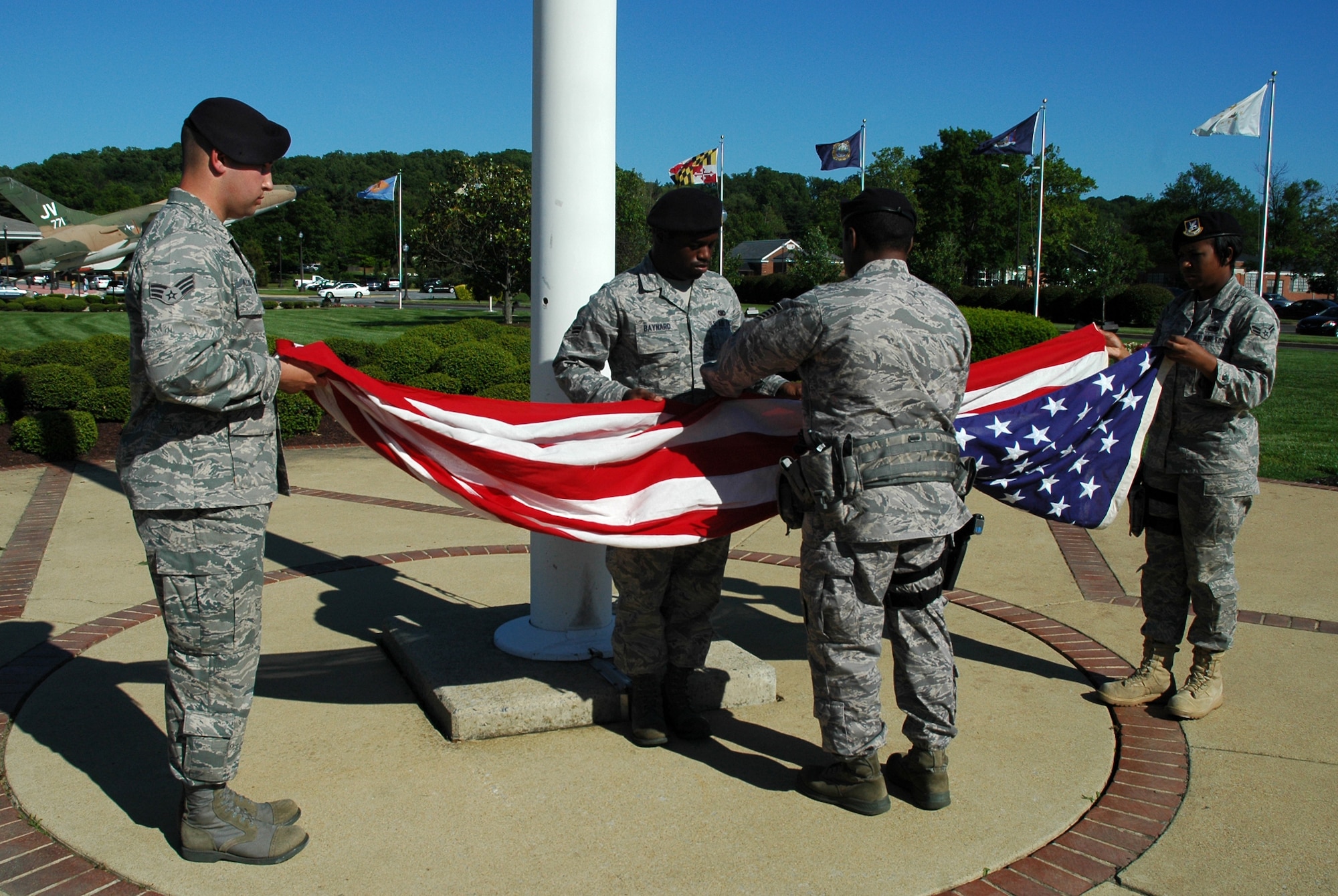 Members of the 11th Security Forces Squadron fold the flag during a retreat ceremony May 20, 2009 on Bolling Air Force Base. The retreat ceremony was held in honor of Chief Airey, to allow individuals unable to attend his funeral at Arlington National Cemetery on May 28 a chance to pay their respects. (U.S. Air Force photo by Airman 1st Class Katherine Windish)