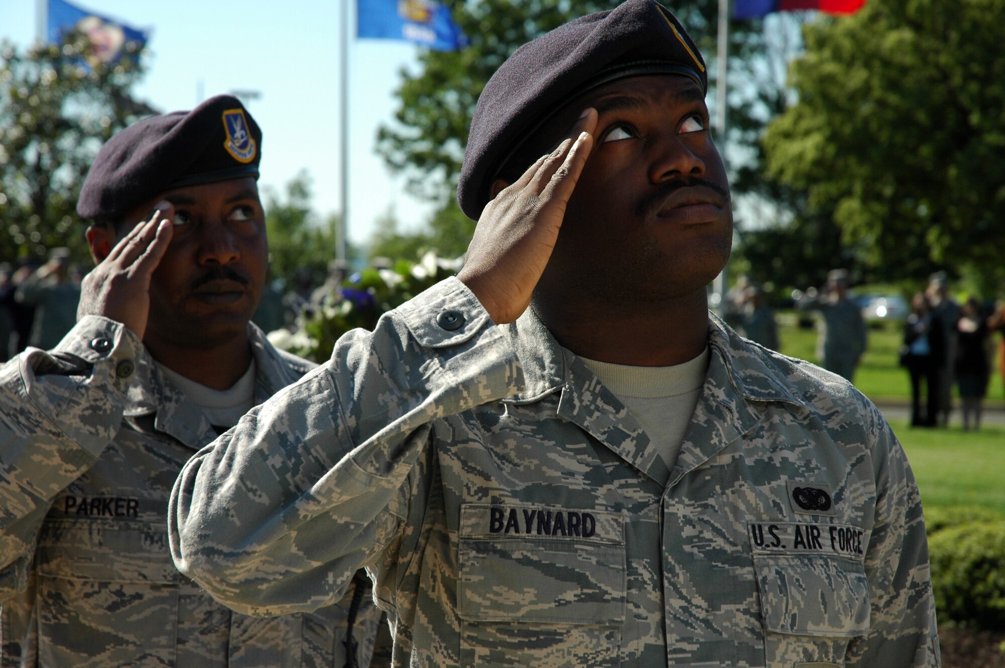 Airman 1st Class James Baynard and Tech. Sgt. James Parker, 11th Security Forces Squadron, prepare to catch the flag as it is lowered during a retreat ceremony May 20, 2009 on Bolling Air Force Base. The retreat ceremony was held in honor of Chief Airey, to allow individuals unable to attend his funeral at Arlington National Cemetery on May 28 a chance to pay their respects. (U.S. Air Force photo by Airman 1st Class Katherine Windish)