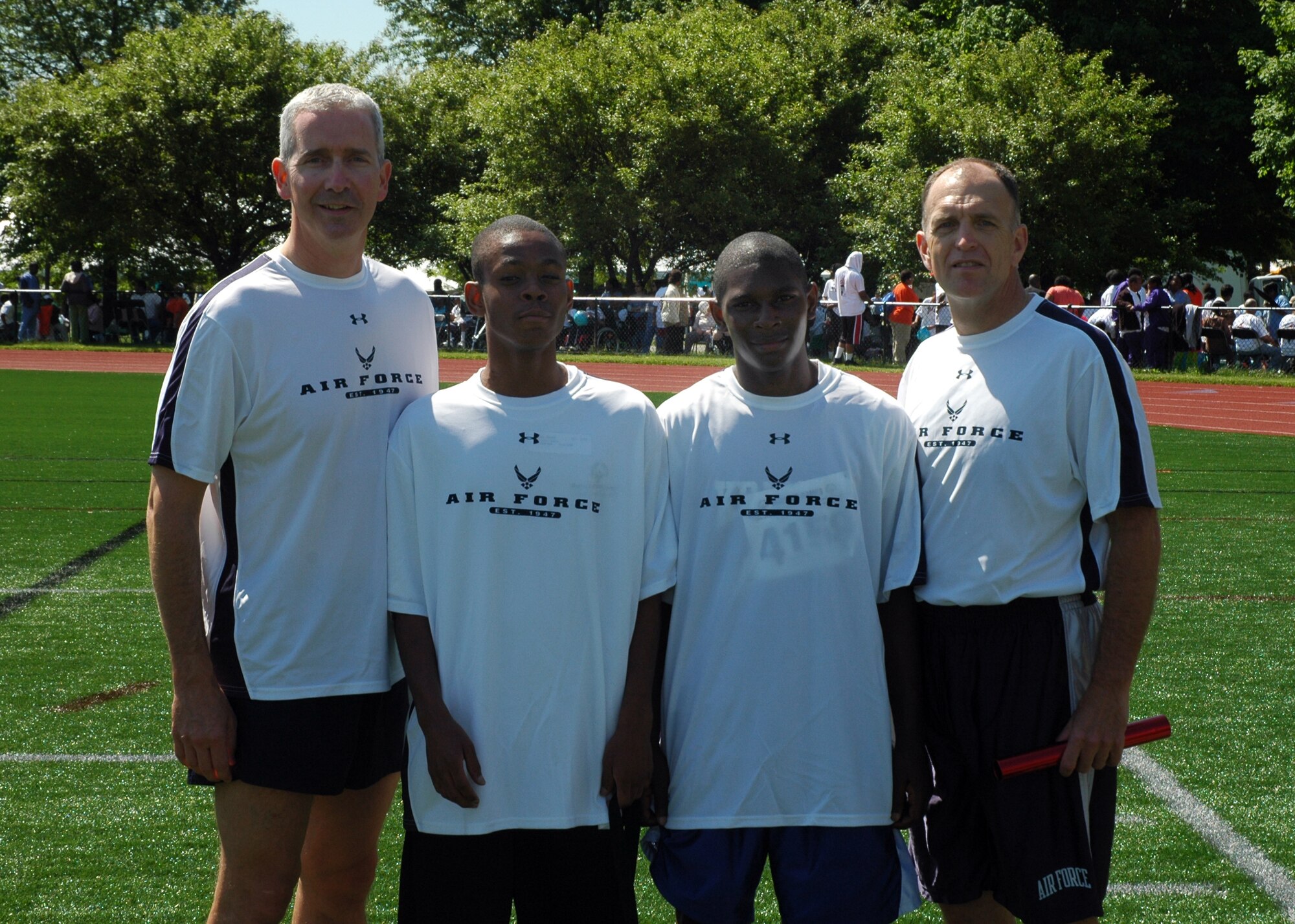 From left to right, Col. Jon A. Roop, 11th Wing commander, Daniel Mathis, Isaish Waford and Maj. Gen. Ralph Jodice, Air Force District of Washington commander, pose for a photo after they competed in a 4x4 100-meter relay May 20 at the 2009 Special Olympics D.C. Summer Games at the Catholic University of America in Washington, D.C. (U.S. Air Force photo by Senior Airman R. Michael Longoria)