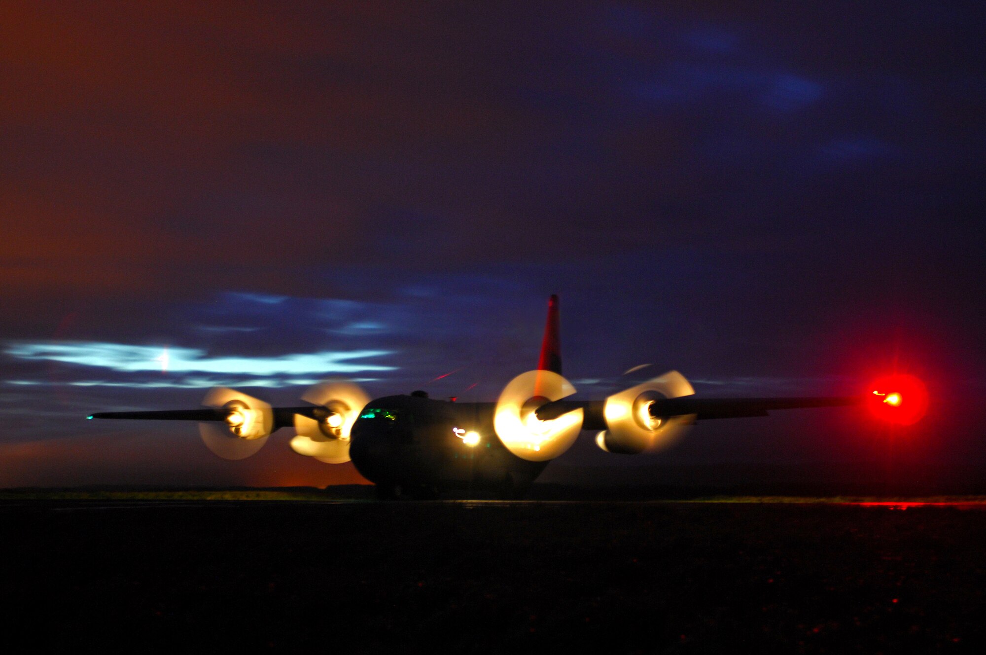 A United States Air Force C-130 Hercules from Ramstein Air Base prepares for a combat offload in the dead of night during an Operational Readiness Exercise, May 19, 2009, West Freugh Airfield, Scotland. (U.S. Air Force photo by Senior Airman Kenny Holston)